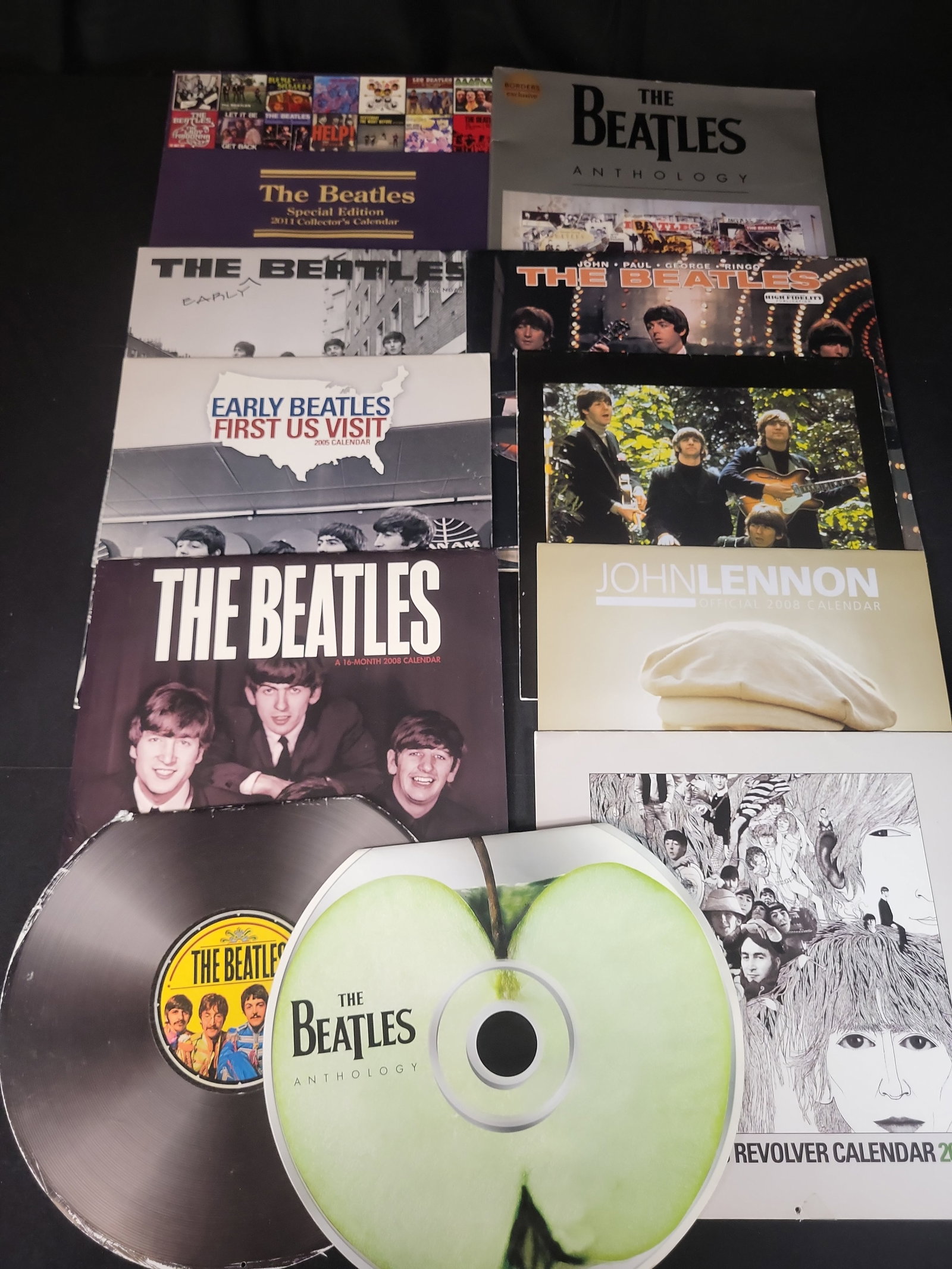 I02558 | A Collection of Ten Beatles and John Lennon Official Wall Calendars, 2002-2011: BID PER WHAT YOU SEE IN THE PHOTO, NOT THE AI GENERATED TITLES AND DESCRIPTIONS! A Collection of Ten Beatles and John Lennon Official Wall Calendars, 2002-2011 This collection consists of ten pieces o