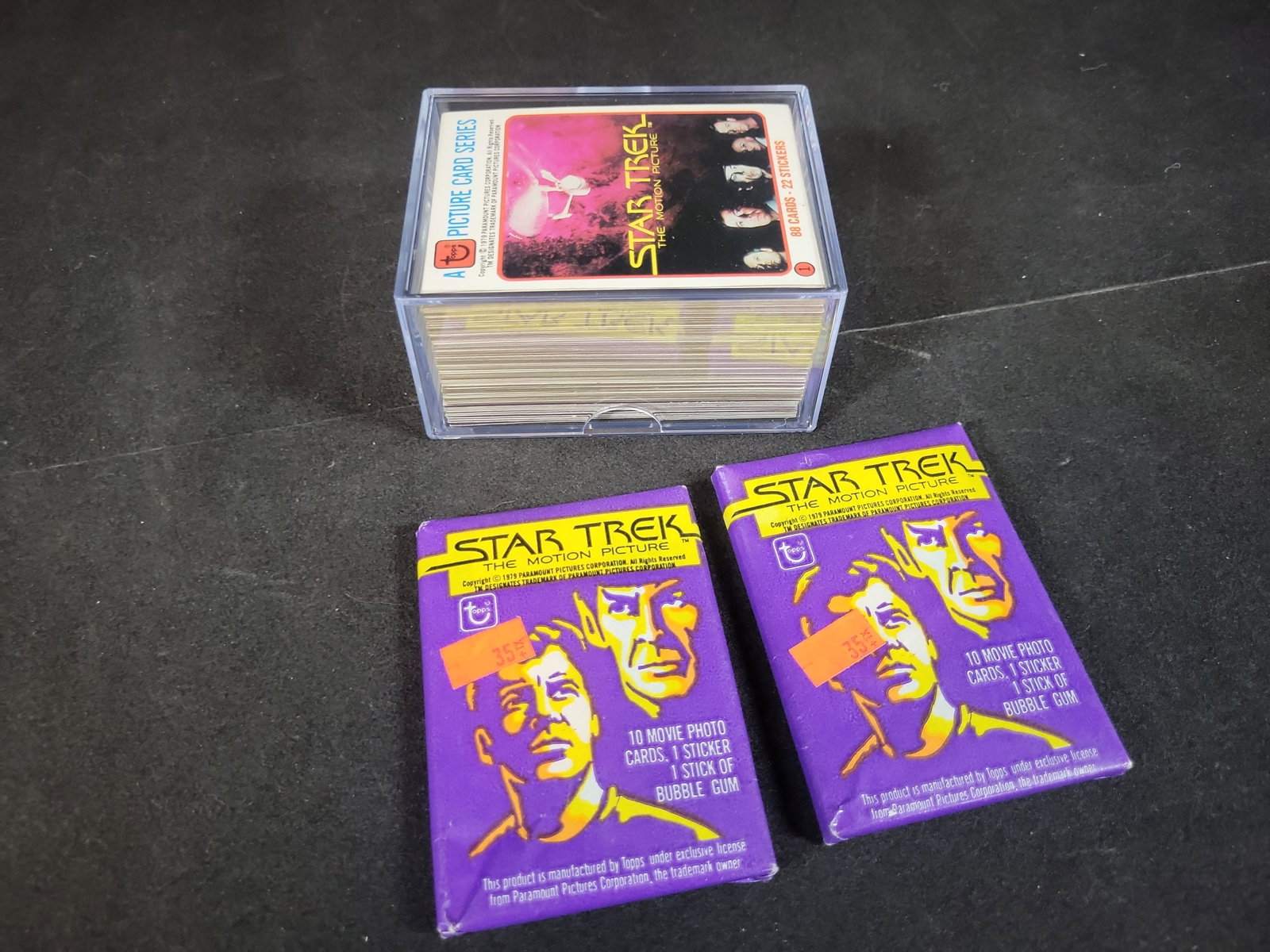 I02916 | A Collection of 1979 Topps Star Trek The Motion Picture Trading Cards and Unopened Wax: BID PER WHAT YOU SEE IN THE PHOTO, NOT THE AI GENERATED TITLES AND DESCRIPTIONS! A Collection of 1979 Topps Star Trek The Motion Picture Trading Cards and Unopened Wax Packs This collection consists o
