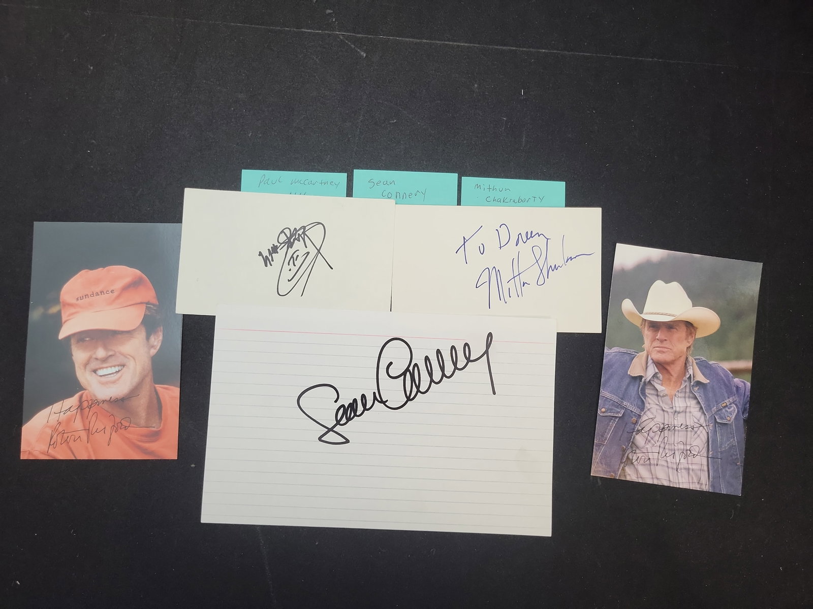 I03382 | A Collection of Five Celebrity Autographs Including Robert Redford and Ricky Van Shelton: BID PER WHAT YOU SEE IN THE PHOTO, NOT THE AI GENERATED TITLES AND DESCRIPTIONS! This collection consists of five individual celebrity autographs on various formats. It features two color photographs 
