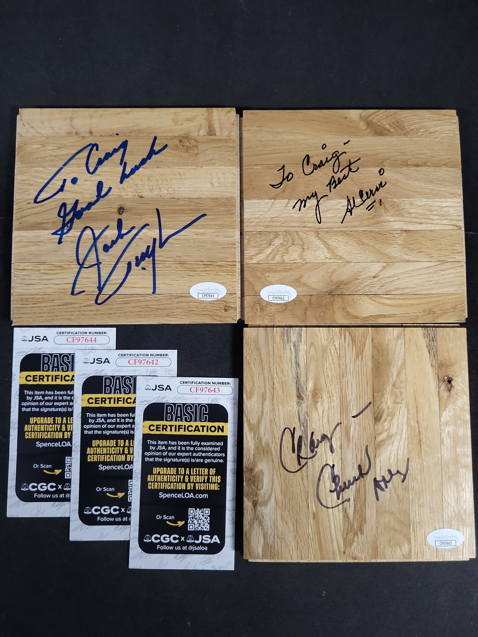 I03434 | A Trio of Autographed Basketball Court Floor Segments Featuring Al Cervi, Chuck Daly, and: BID PER WHAT YOU SEE IN THE PHOTO, NOT THE AI GENERATED TITLES AND DESCRIPTIONS! A collection of three autographed basketball court flooring segments featuring the signatures of prominent figures in b