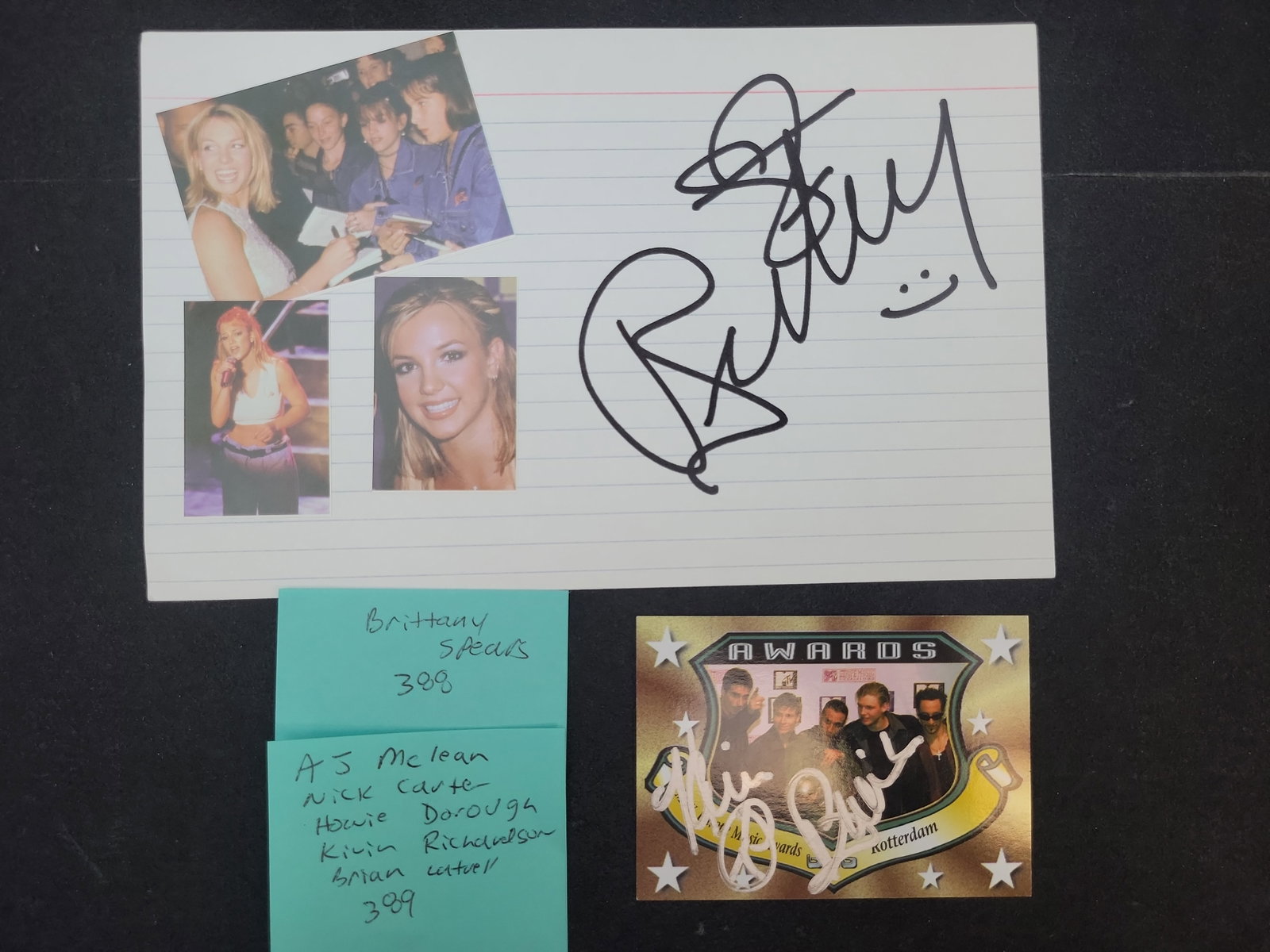 I03365 | Two Pop Music Autographed Items featuring Britney Spears and the Backstreet Boys: BID PER WHAT YOU SEE IN THE PHOTO, NOT THE AI GENERATED TITLES AND DESCRIPTIONS! This lot consists of two separate pieces of pop culture memorabilia. The first item is a white lined index card featuri