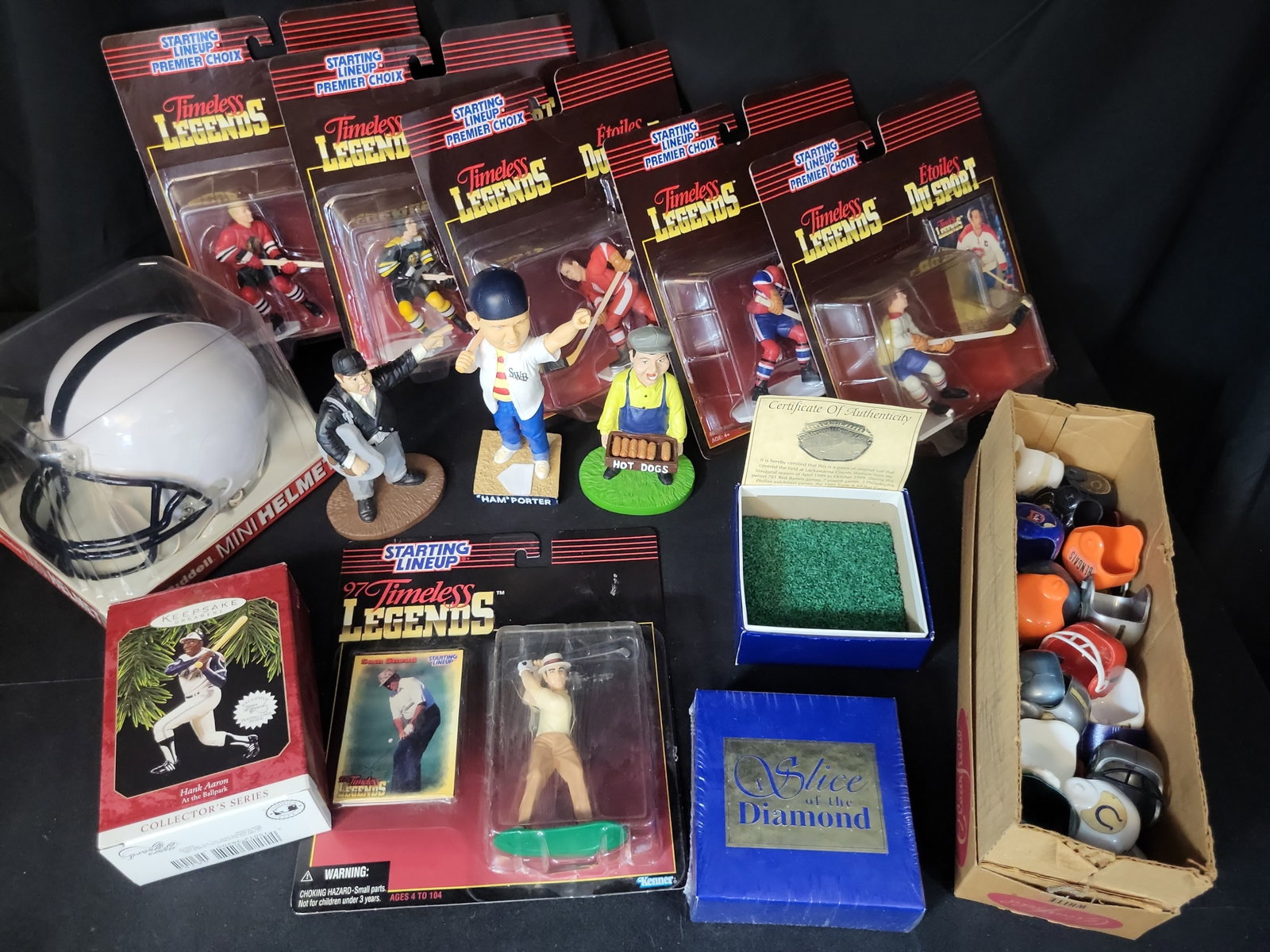 I03054 | An Assortment of Sports Memorabilia including Starting Lineup Figures, Bobbleheads, and (1 of 14)