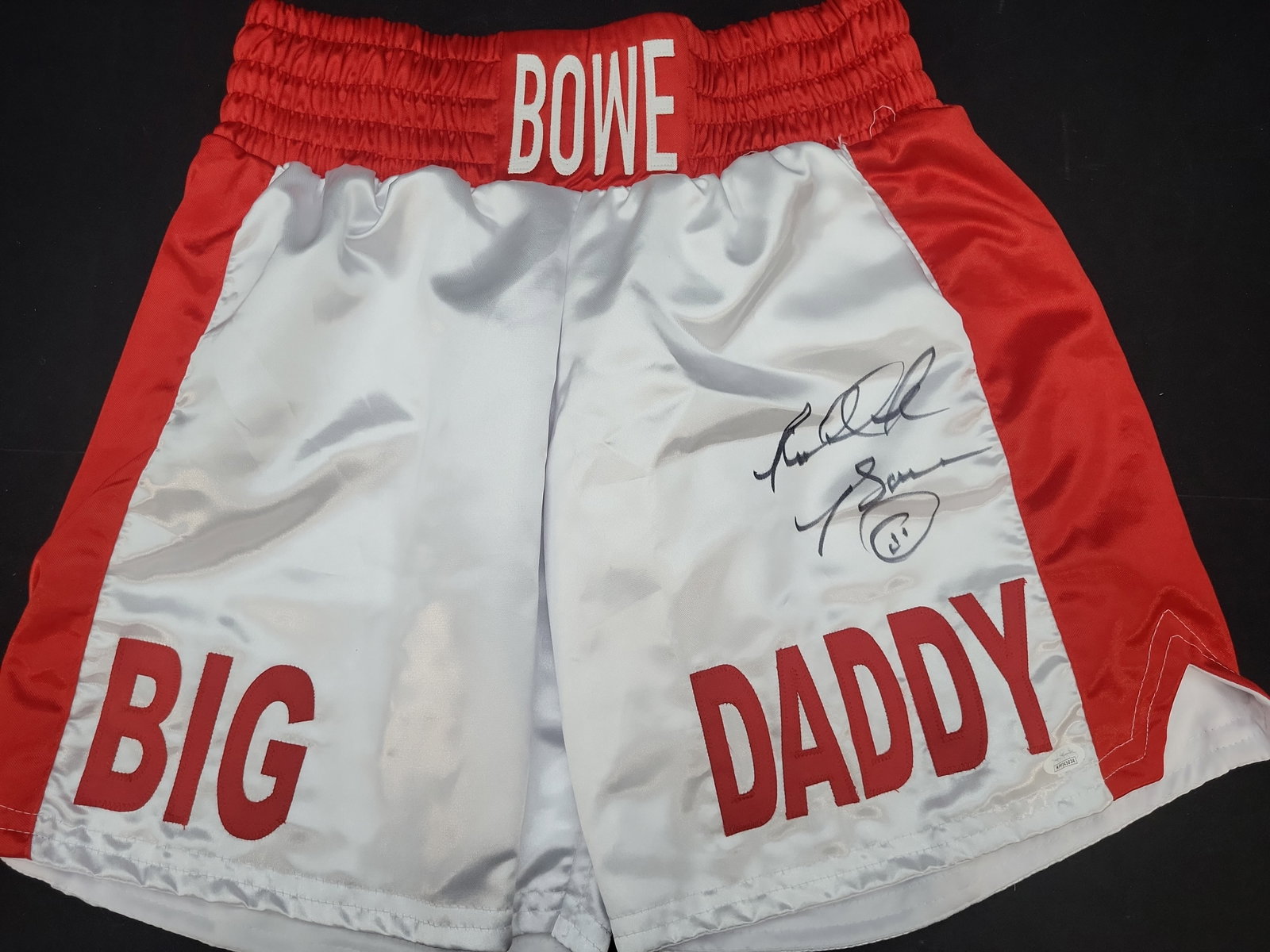 I03570 | Riddick Bowe Autographed Big Daddy Boxing Trunks with JSA Authentication: BID PER WHAT YOU SEE IN THE PHOTO, NOT THE AI GENERATED TITLES AND DESCRIPTIONS! Riddick Bowe Autographed Big Daddy Boxing Trunks with JSA Authentication A pair of autographed boxing trunks belonging 