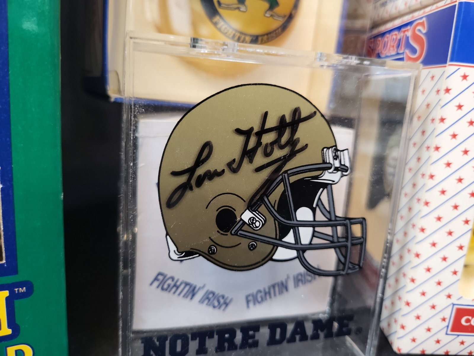 I03056 | A Collection of Four University of Notre Dame Fighting Irish Collectibles Including a Lou: BID PER WHAT YOU SEE IN THE PHOTO, NOT THE AI GENERATED TITLES AND DESCRIPTIONS! A Collection of Four University of Notre Dame Fighting Irish Collectibles Including a Lou Holtz Signed Desk Accessory A