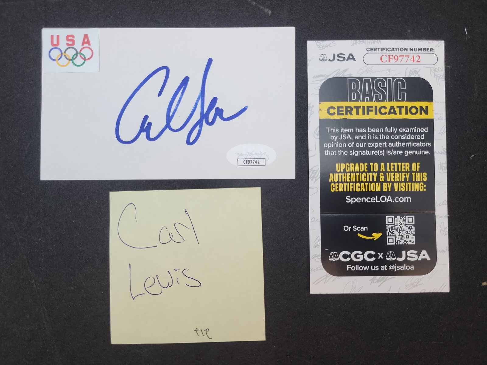 I03378 | Carl Lewis Autographed Team USA Olympic Card with JSA Authentication: BID PER WHAT YOU SEE IN THE PHOTO, NOT THE AI GENERATED TITLES AND DESCRIPTIONS! This lot features an autographed card signed by American track and field legend Carl Lewis. The signature is rendered i