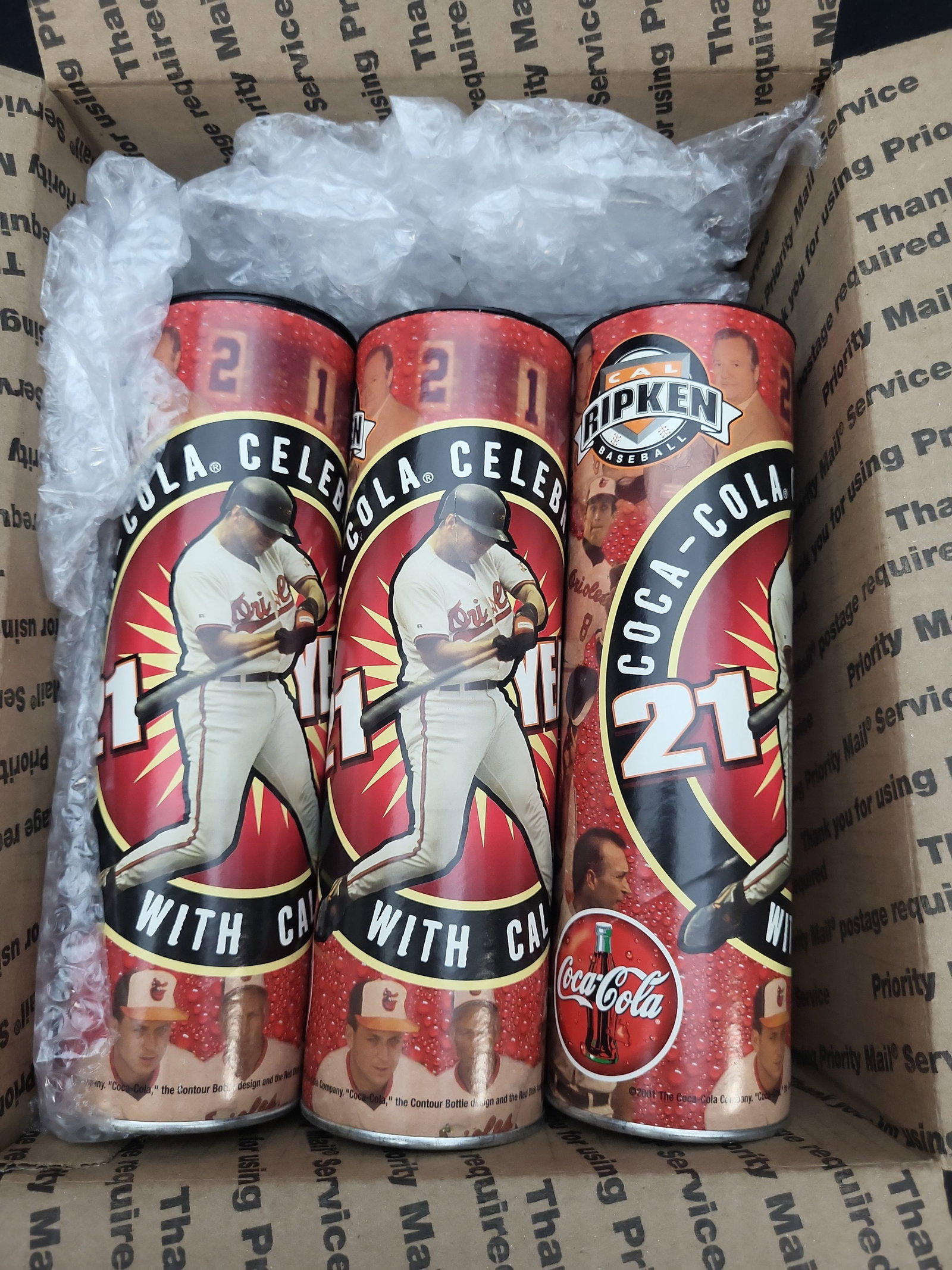 I03325 | A Collection of Cal Ripken Jr. Baltimore Orioles Commemorative Coca-Cola Cans: BID PER WHAT YOU SEE IN THE PHOTO, NOT THE AI GENERATED TITLES AND DESCRIPTIONS! This collection consists of commemorative 12 oz. Coca-Cola cans produced in 2001 to celebrate the career of Baltimore O
