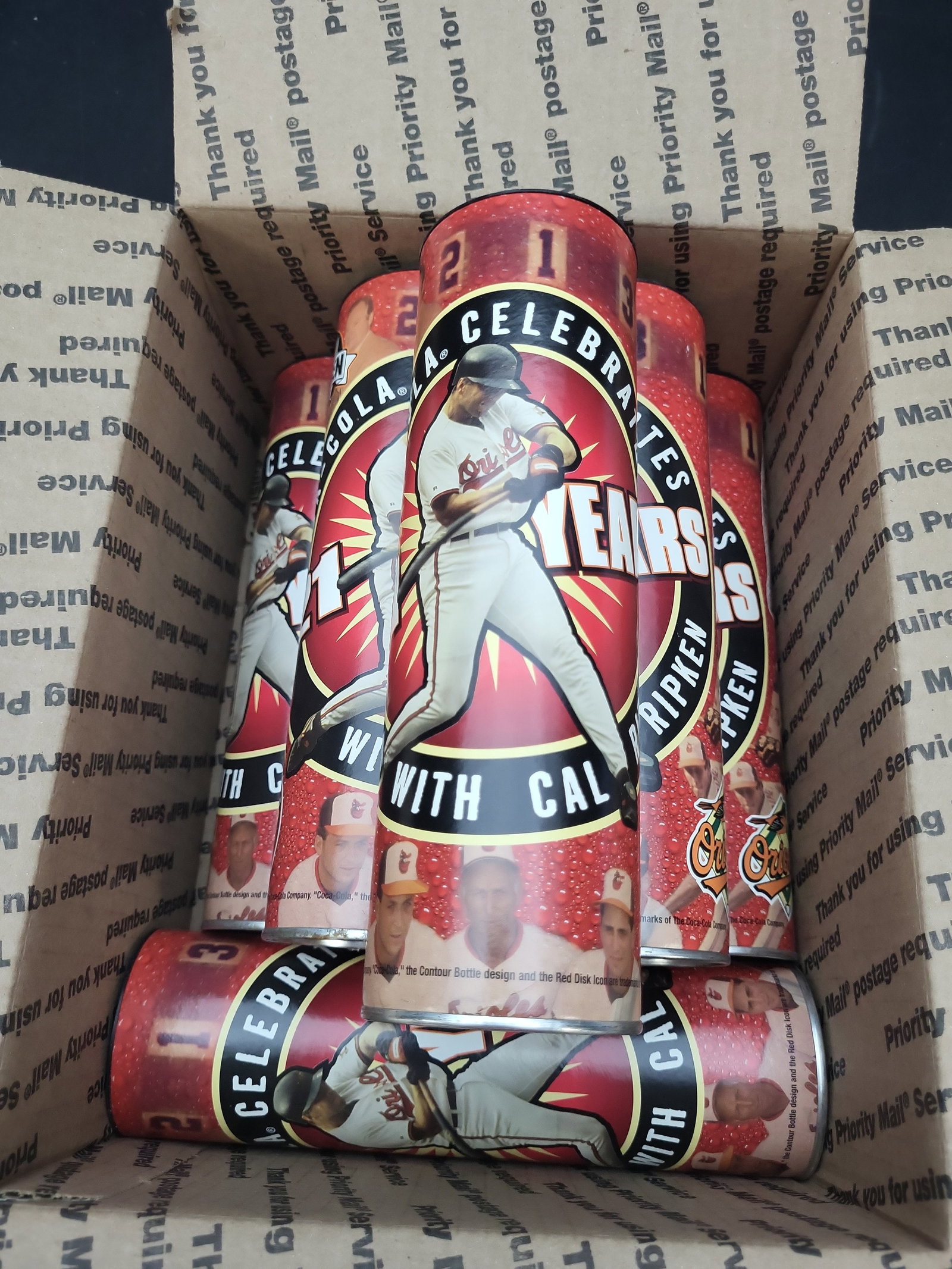 I03326 | A Collection of Coca-Cola Baltimore Orioles Cal Ripken Jr. 21 Years Commemorative Canisters: BID PER WHAT YOU SEE IN THE PHOTO, NOT THE AI GENERATED TITLES AND DESCRIPTIONS! A collection of vintage commemorative metal canisters produced by Coca-Cola, celebrating Major League Baseball Hall of 