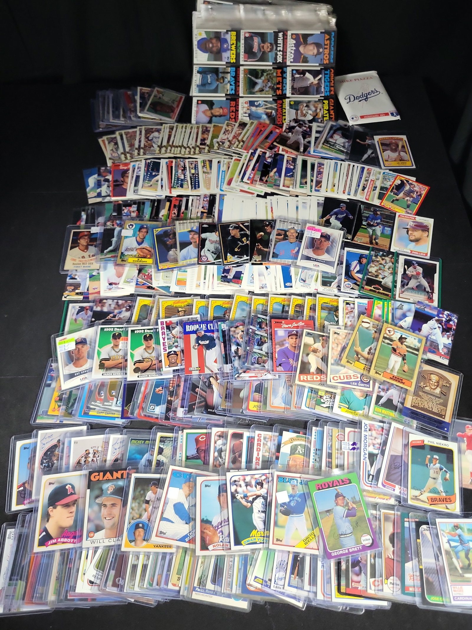 I03839 | A Collection of Multi-Era Baseball Trading Cards and Memorabilia Featuring Stars Hall of: BID PER WHAT YOU SEE IN THE PHOTO, NOT THE AI GENERATED TITLES AND DESCRIPTIONS! An assortment of baseball trading cards and sports memorabilia spanning from the late 1970s to approximately 2022. The 