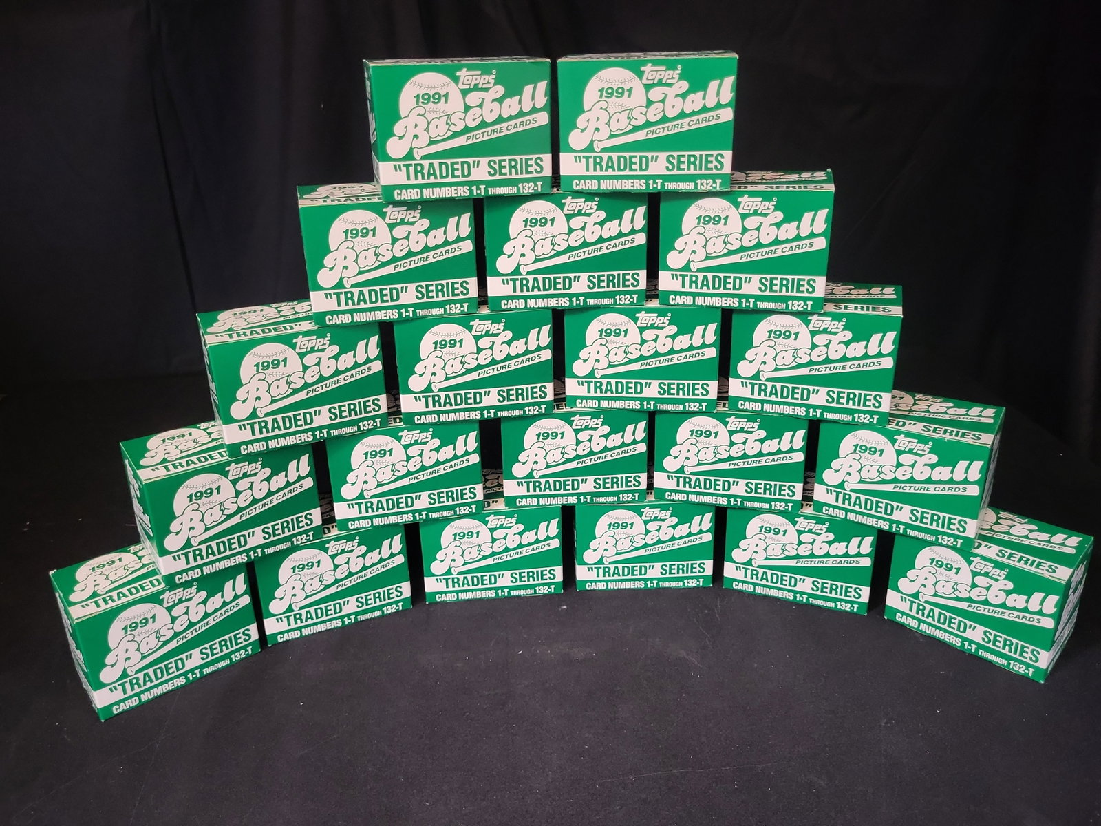 I03253 | Lot of (20) 1991 Topps Baseball Traded Series Complete Box Sets: BID PER WHAT YOU SEE IN THE PHOTO, NOT THE AI GENERATED TITLES AND DESCRIPTIONS! This collection contains twenty original, complete box sets of the 1991 Topps Baseball Traded Series. Each set is house