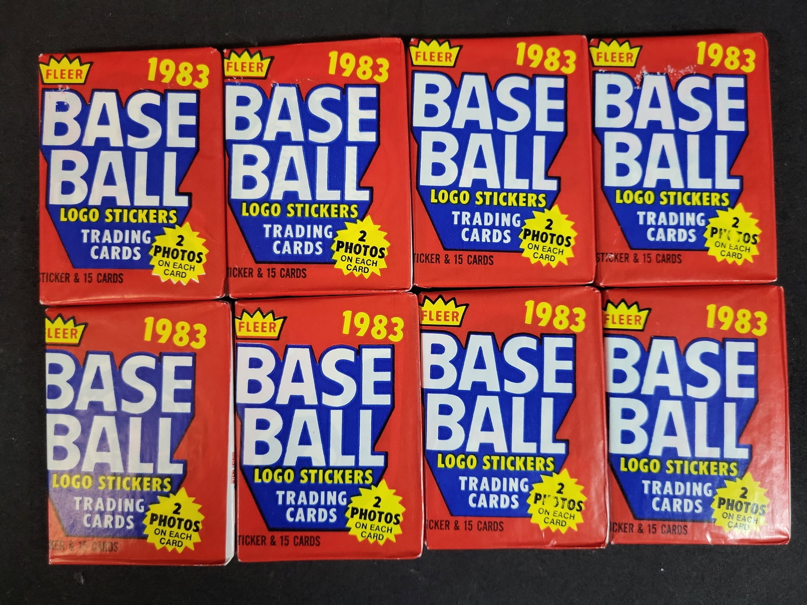 I03930 | Eight 1983 Fleer Baseball Unopened Wax Packs: BID PER WHAT YOU SEE IN THE PHOTO, NOT THE AI GENERATED TITLES AND DESCRIPTIONS! This lot consists of eight original, unopened 1983 Fleer Baseball trading card wax packs. According to the manufacturer