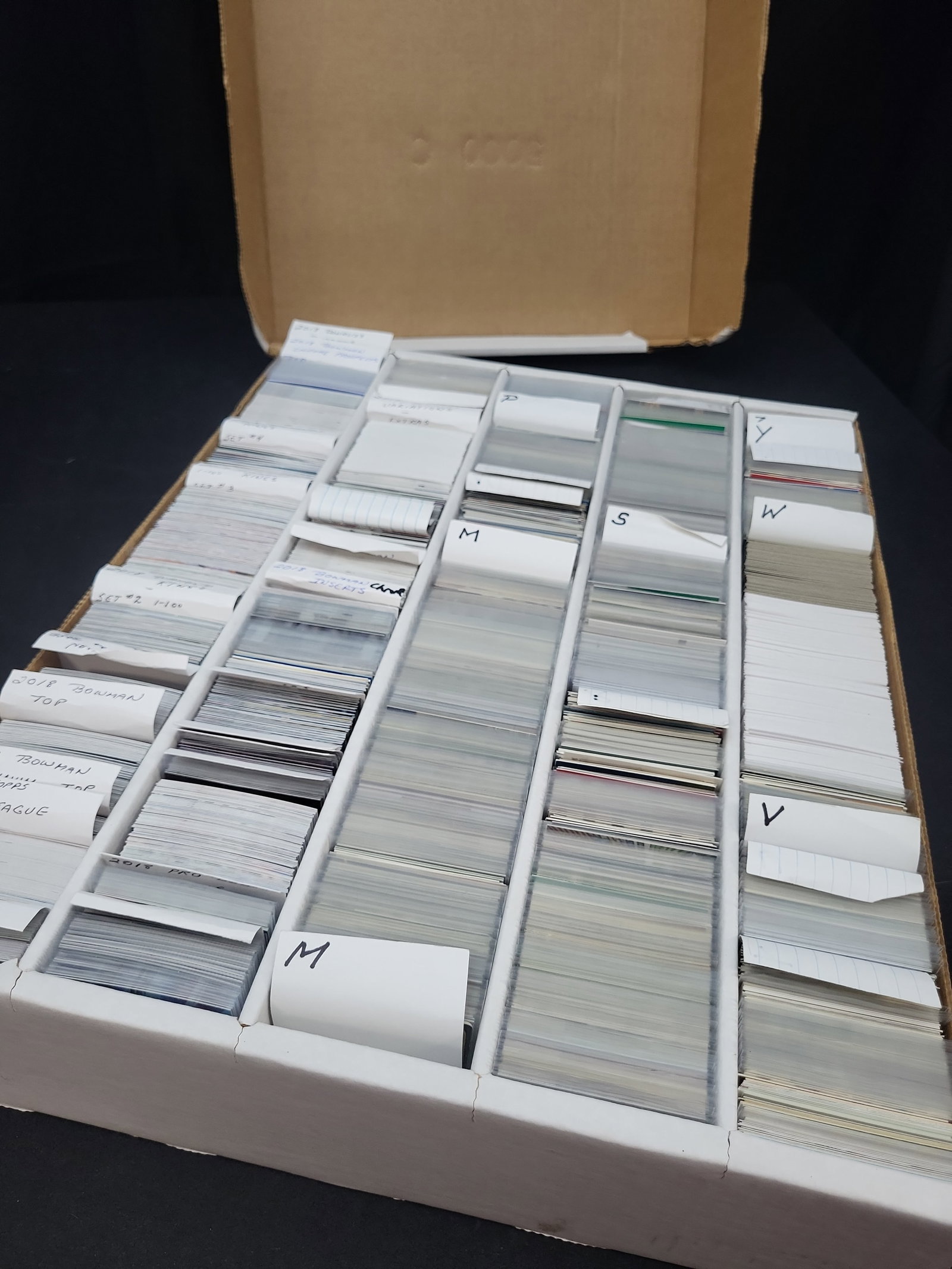 I03318 | A Large Organized Collection of Modern and Semi-Vintage Baseball Trading Cards: BID PER WHAT YOU SEE IN THE PHOTO, NOT THE AI GENERATED TITLES AND DESCRIPTIONS! An assortment of modern and semi-vintage baseball trading cards housed in a multi-row corrugated cardboard storage box.