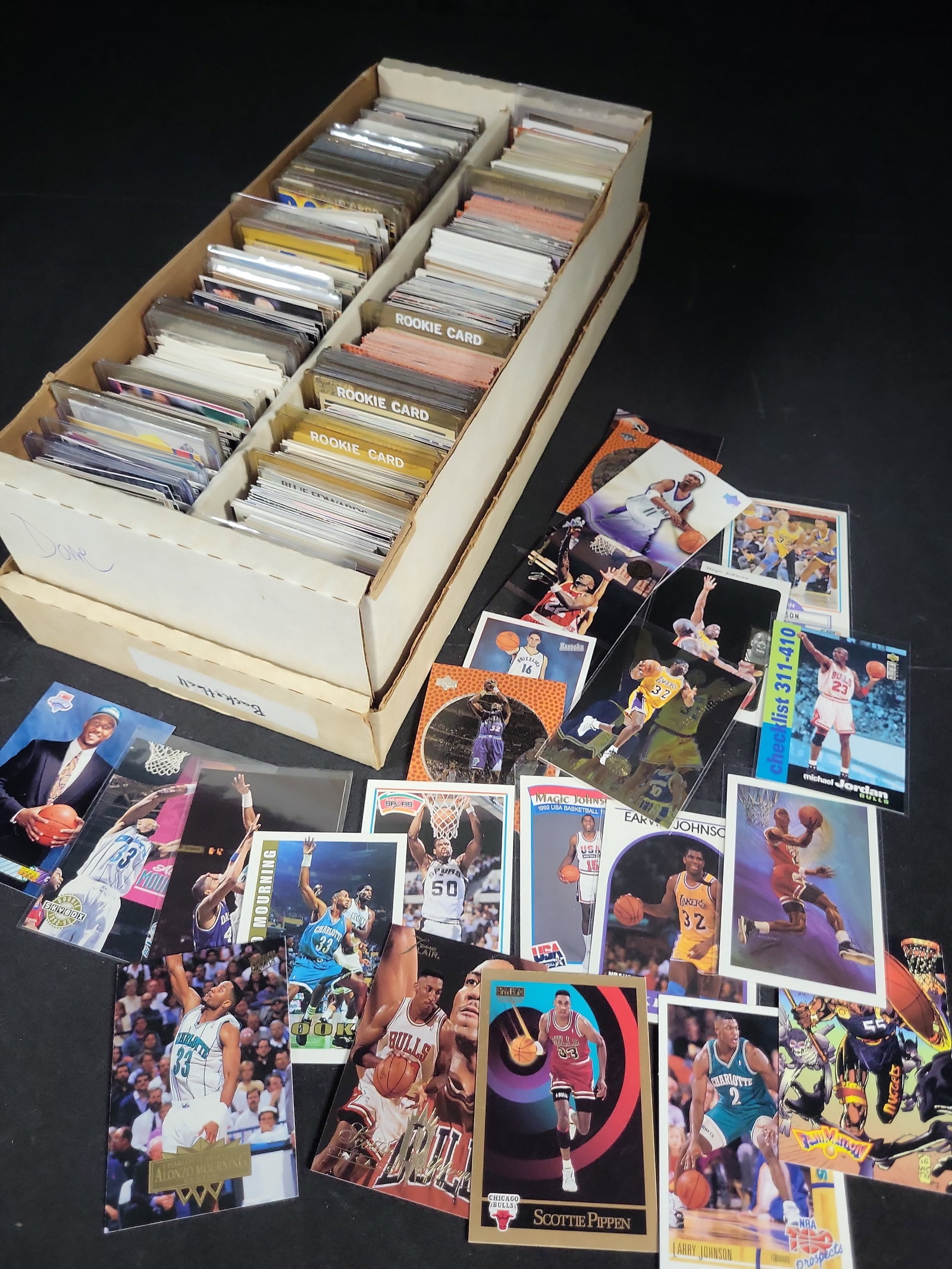 I03822 | An Assortment of Vintage 1990s Basketball Trading Cards Featuring Michael Jordan and: BID PER WHAT YOU SEE IN THE PHOTO, NOT THE AI GENERATED TITLES AND DESCRIPTIONS! This lot comprises an assortment of vintage basketball trading cards, largely dating from the early to mid-1990s. The c