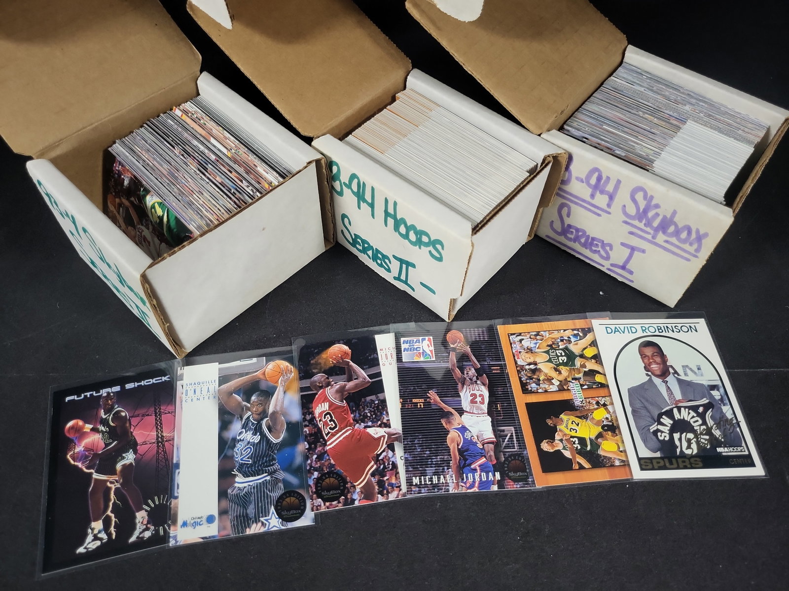 I03804 | A Collection of 1993-94 Skybox and NBA Hoops Basketball Trading Cards: BID PER WHAT YOU SEE IN THE PHOTO, NOT THE AI GENERATED TITLES AND DESCRIPTIONS! This collection consists of several hundred basketball trading cards from the 1993-94 NBA season, organized within thre