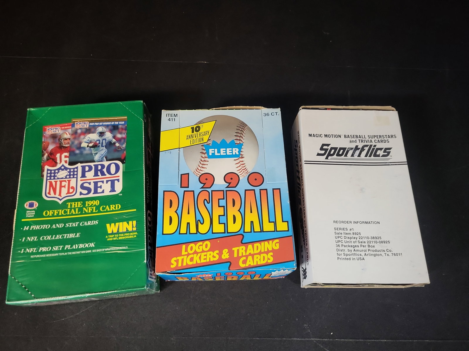 I03228 | A Trio of Vintage Sports Trading Card Boxes Including 1990 Pro Set NFL, 1990 Fleer: BID PER WHAT YOU SEE IN THE PHOTO, NOT THE AI GENERATED TITLES AND DESCRIPTIONS! This lot features a trio of vintage sports trading card boxes from the mid-1980s and 1990, containing football and base