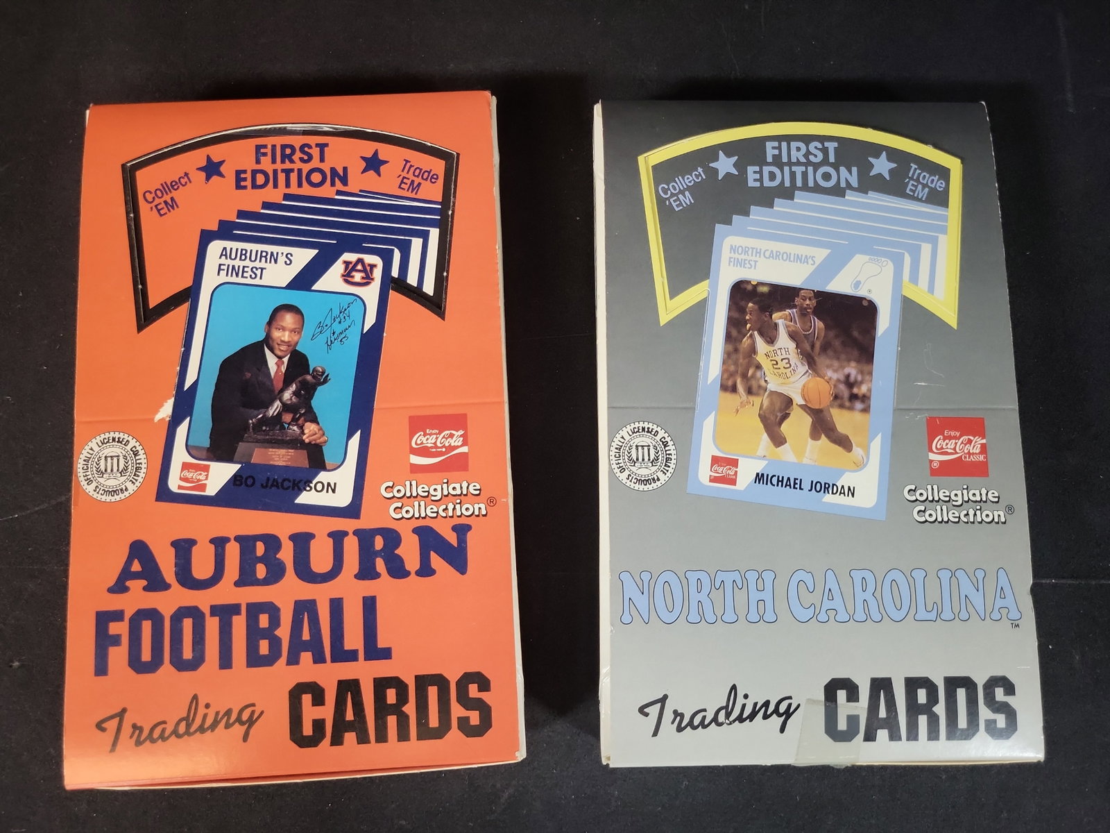 I03229 | Two Collegiate Collection First Edition Trading Card Boxes, Auburn Football and North: BID PER WHAT YOU SEE IN THE PHOTO, NOT THE AI GENERATED TITLES AND DESCRIPTIONS! This lot consists of two vintage sports trading card boxes from the Collegiate Collection series, produced in associati