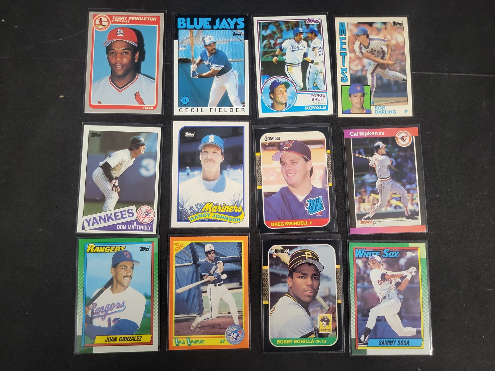 I03164 | A Collection of 12 Vintage Baseball and Crossover Trading Cards Including Rookies and Hall: BID PER WHAT YOU SEE IN THE PHOTO, NOT THE AI GENERATED TITLES AND DESCRIPTIONS! A Collection of 12 Vintage Baseball and Crossover Trading Cards Including Rookies and Hall of Famers 1983-1990 This col