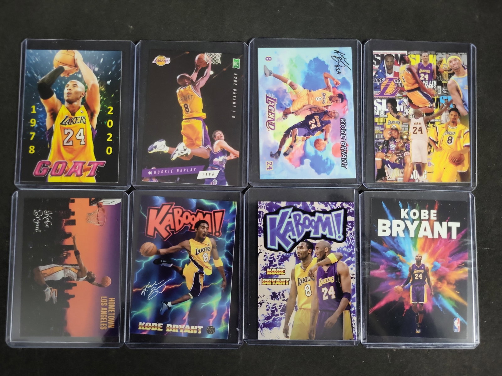 I03282 | A Collection of Eight Kobe Bryant Custom Art and Novelty Basketball Cards: BID PER WHAT YOU SEE IN THE PHOTO, NOT THE AI GENERATED TITLES AND DESCRIPTIONS! This lot consists of eight custom, unlicensed art and novelty basketball cards dedicated to NBA legend Kobe Bryant. The