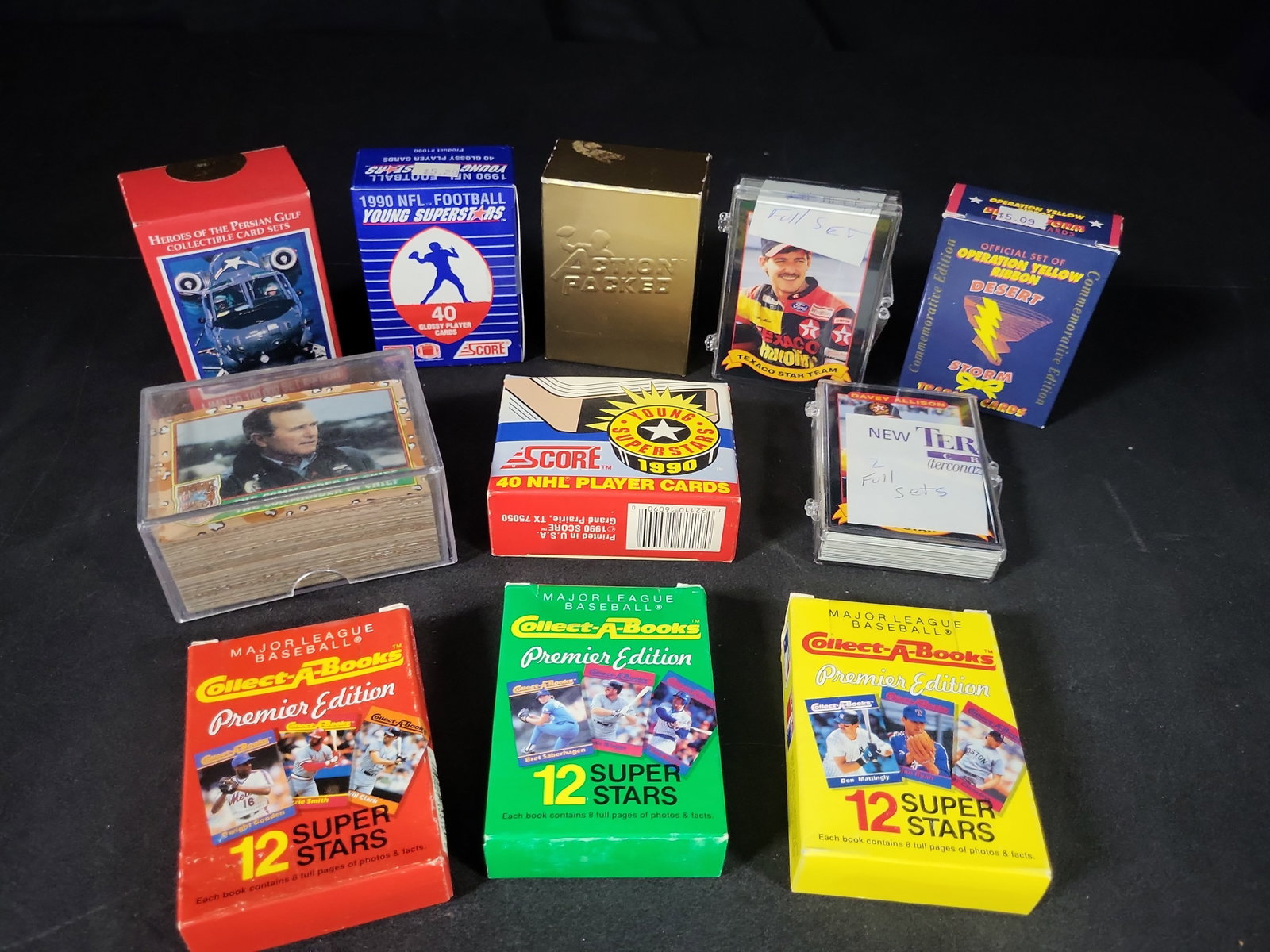 I03220 | A Collection of Assorted 1990s Sports and Desert Storm Trading Card Sets and Collectibles: BID PER WHAT YOU SEE IN THE PHOTO, NOT THE AI GENERATED TITLES AND DESCRIPTIONS! A collection of vintage trading card sets and collectible mini-books dating from the early 1990s, featuring sports and 