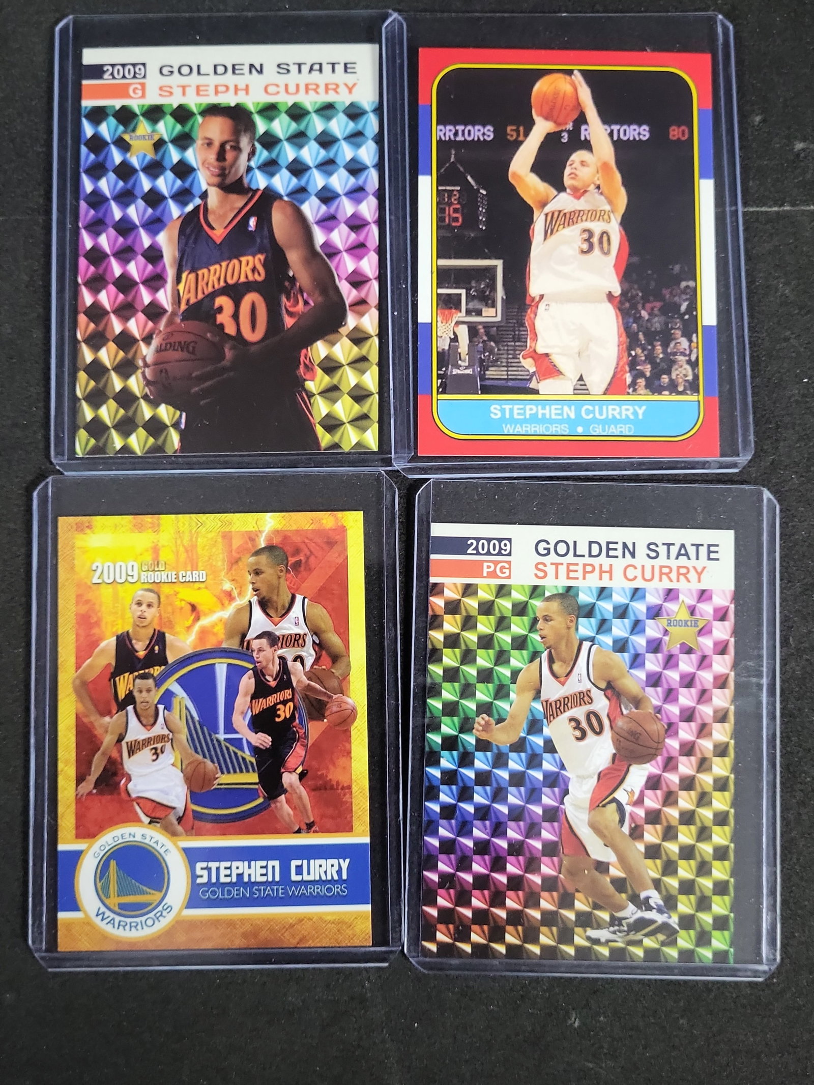 I03271 | A Collection of Four Stephen Curry Unlicensed Custom and Tribute Rookie Style Basketball: BID PER WHAT YOU SEE IN THE PHOTO, NOT THE AI GENERATED TITLES AND DESCRIPTIONS! This lot consists of four unlicensed, custom, or tribute-style basketball cards featuring Stephen Curry of the Golden S