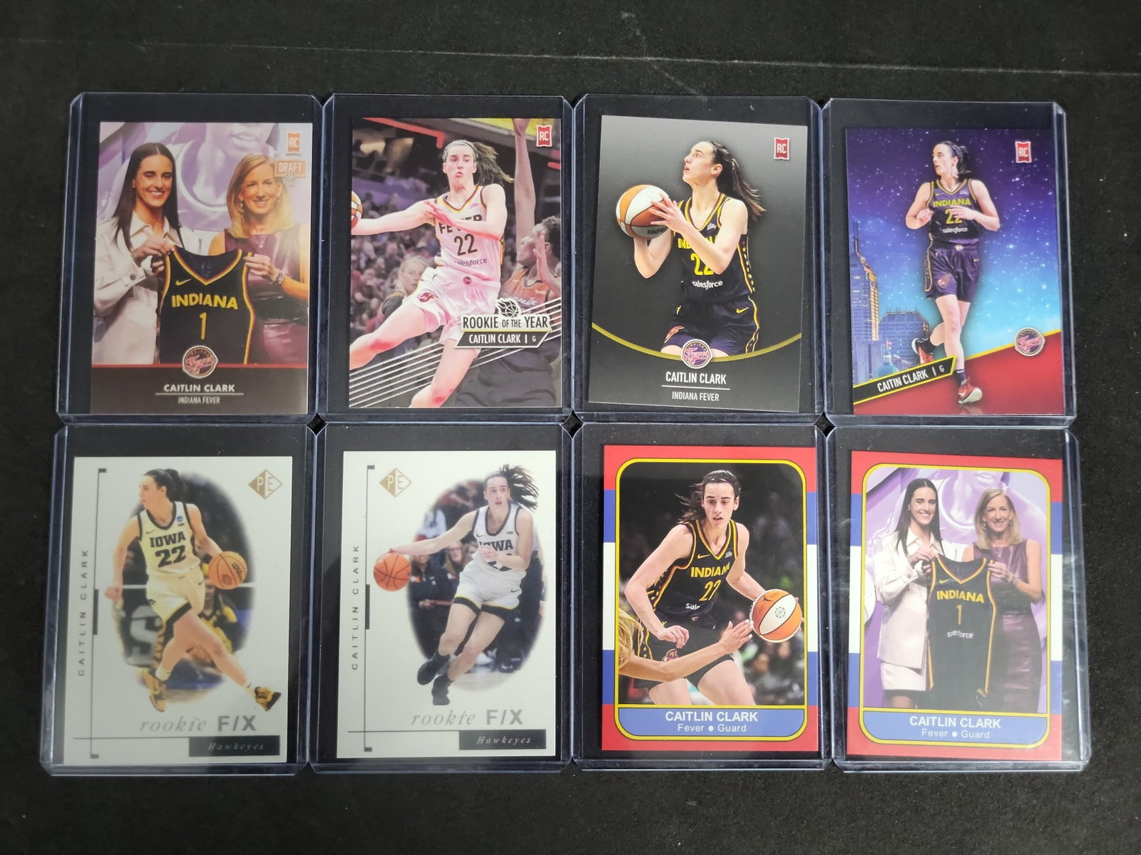 I03274 | A Group of Eight Caitlin Clark Novelty and Custom Rookie Themed Trading Cards: BID PER WHAT YOU SEE IN THE PHOTO, NOT THE AI GENERATED TITLES AND DESCRIPTIONS! This lot consists of a group of eight unlicensed, custom art trading cards featuring basketball star Caitlin Clark duri