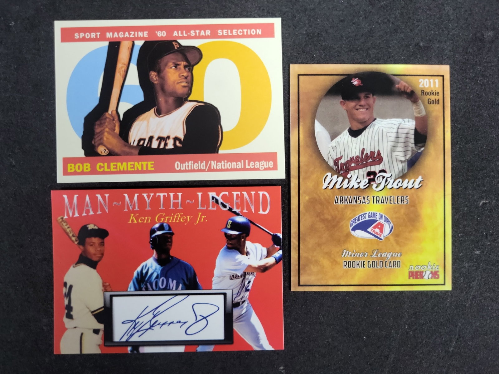 I03584 | A Trio of Baseball Trading Cards Featuring Bob Clemente, Ken Griffey Jr., and Mike Trout (1 of 2)