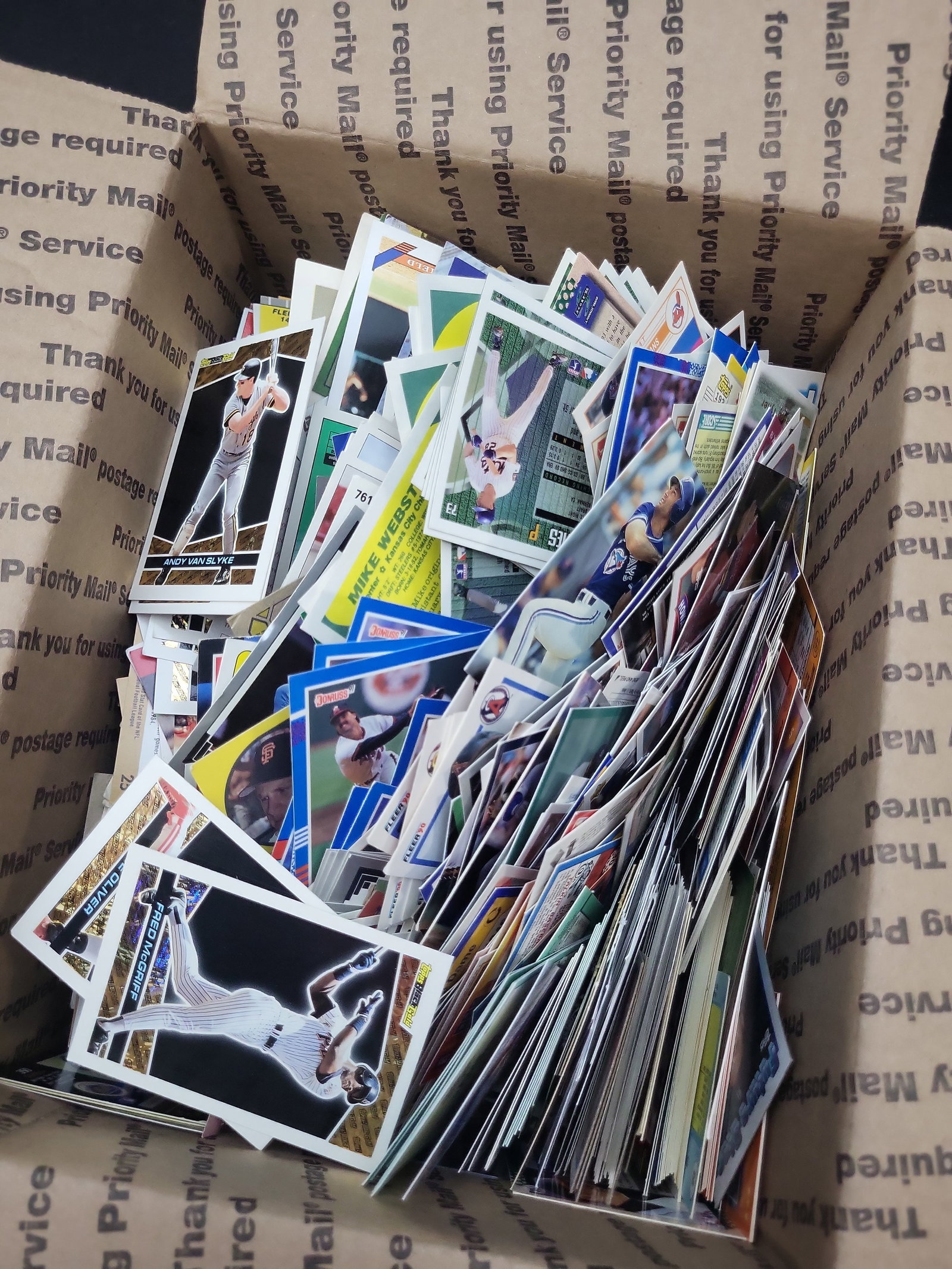 I03330 | An Assortment of Vintage Sports Trading Cards Including 1993 Topps Black Gold Inserts: BID PER WHAT YOU SEE IN THE PHOTO, NOT THE AI GENERATED TITLES AND DESCRIPTIONS! This lot consists of a large, loose assortment of sports trading cards, primarily featuring baseball cards from the lat