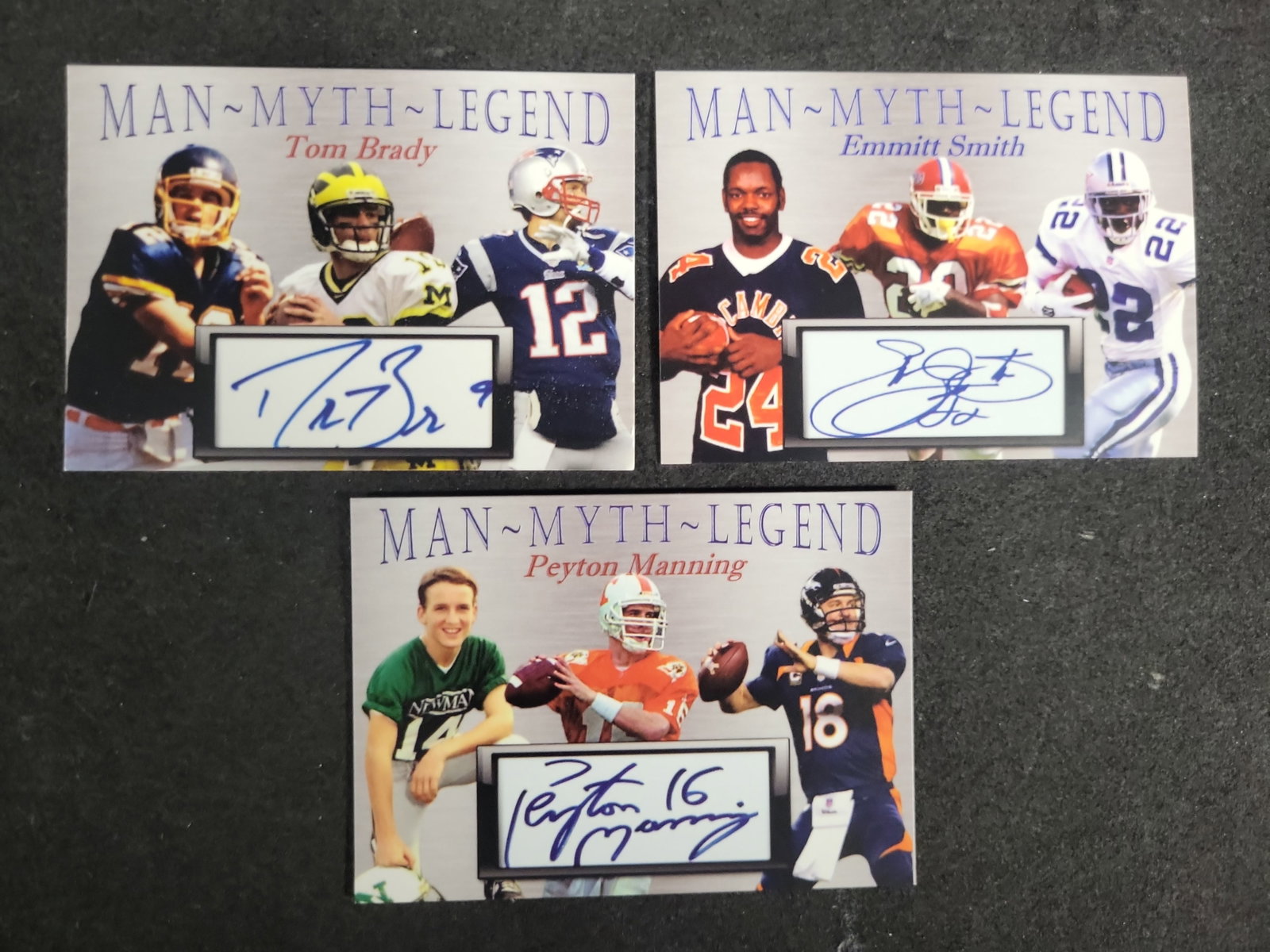 I03593 | A Trio of Man-Myth-Legend Football Cards Featuring Facsimile Cut Autographs of Tom Brady: BID PER WHAT YOU SEE IN THE PHOTO, NOT THE AI GENERATED TITLES AND DESCRIPTIONS! A Trio of Man-Myth-Legend Football Cards Featuring Facsimile Cut Autographs of Tom Brady Emmitt Smith and Peyton Mannin