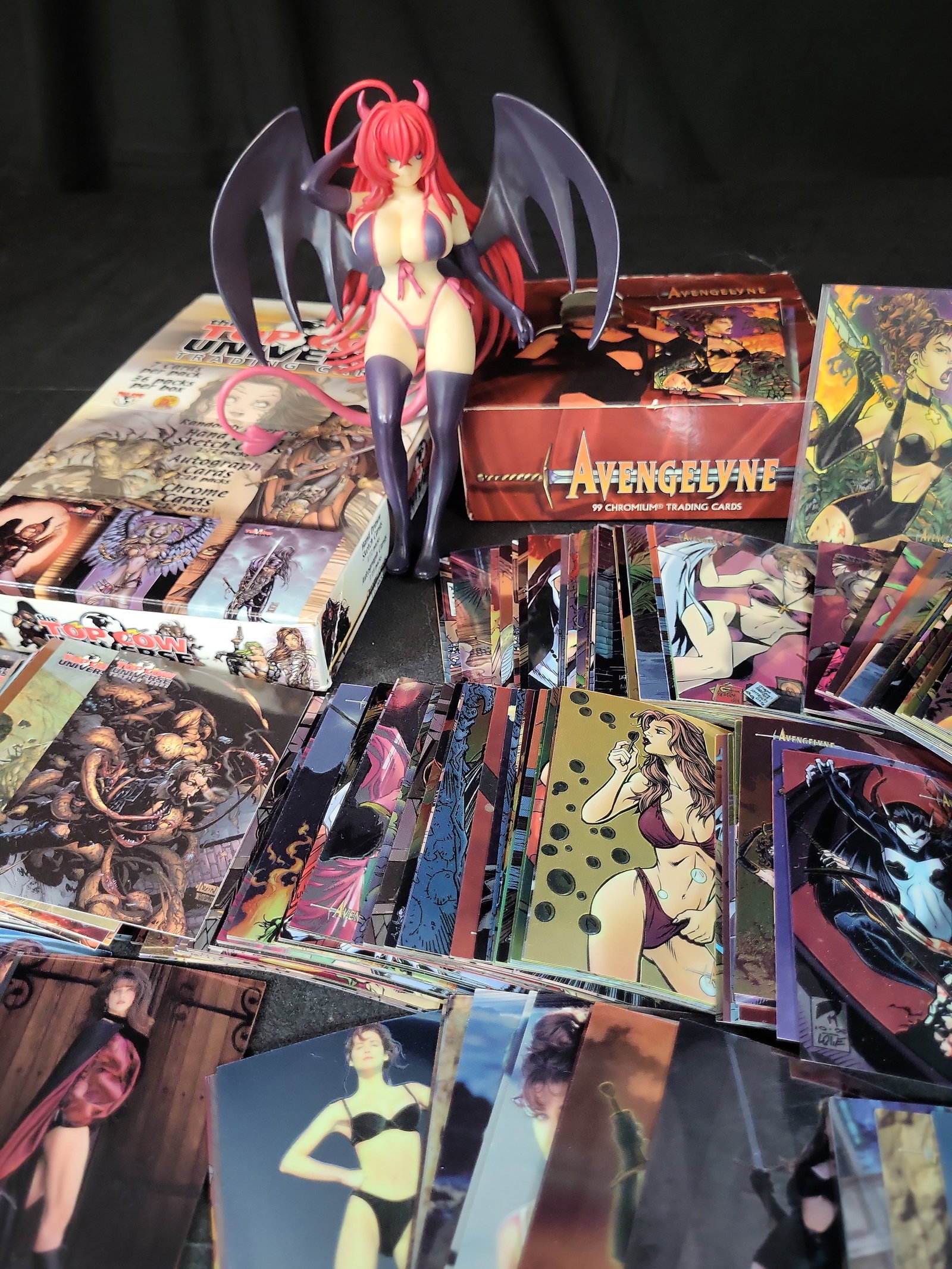 I03664 | A Collection of Top Cow and Avengelyne Trading Cards and a Darkstalkers Lilith Aensland: BID PER WHAT YOU SEE IN THE PHOTO, NOT THE AI GENERATED TITLES AND DESCRIPTIONS! A Collection of Top Cow and Avengelyne Trading Cards and a Darkstalkers Lilith Aensland Figure This lot features an ass