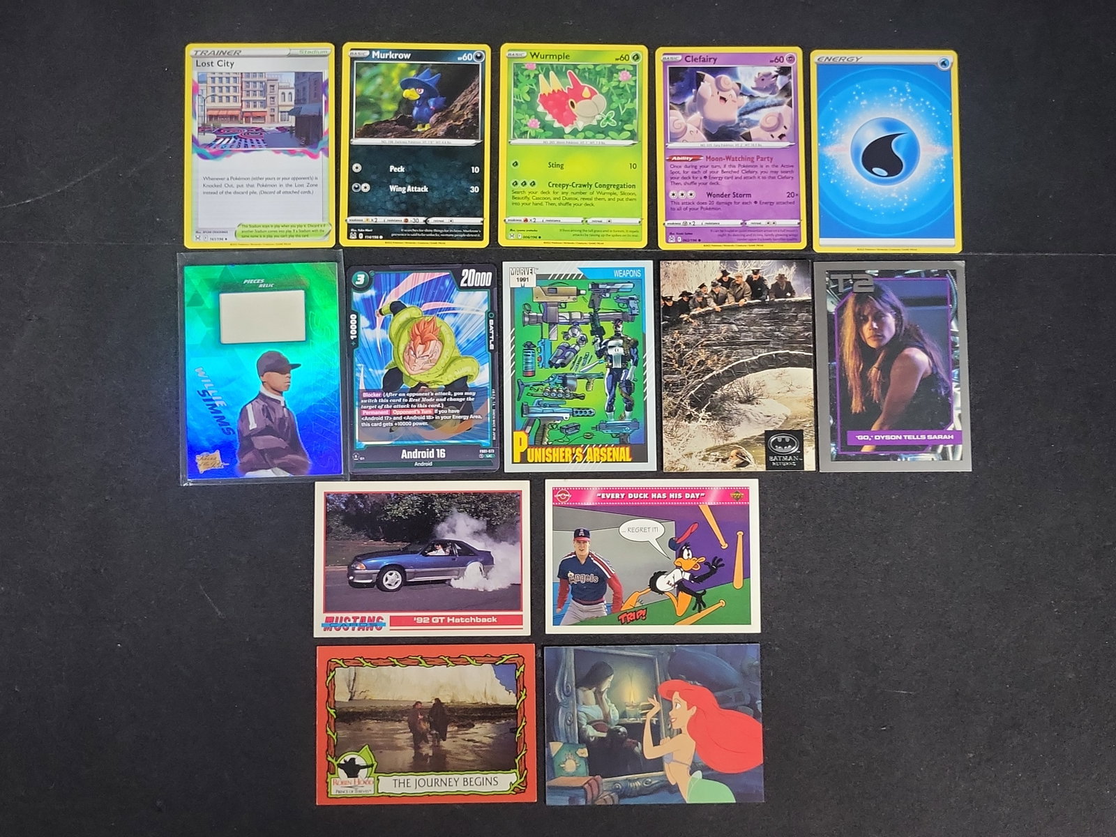 I03168 | An Assortment of 14 Trading and Collectible Cards Including Pokemon, Marvel, and Film: BID PER WHAT YOU SEE IN THE PHOTO, NOT THE AI GENERATED TITLES AND DESCRIPTIONS! An Assortment of 14 Trading and Collectible Cards Including Pokemon, Marvel, and Film Properties This lot comprises 14 