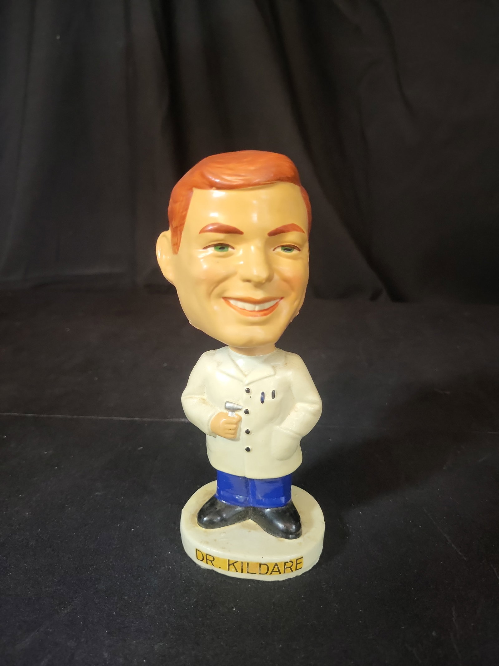 I03255 | Vintage Dr. Kildare Bobblehead Nodder: BID PER WHAT YOU SEE IN THE PHOTO, NOT THE AI GENERATED TITLES AND DESCRIPTIONS! Produced under license for Metro-Goldwyn-Mayer (MGM) Productions, this vintage bobblehead nodder depicts the character 