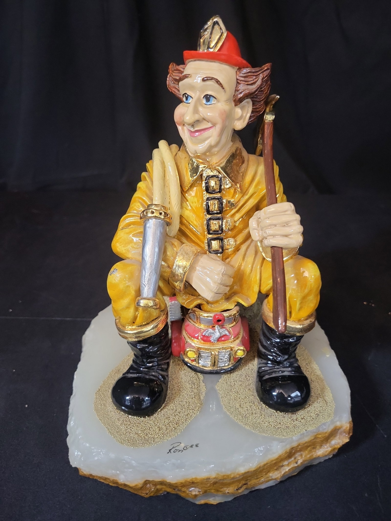I03209 | Ron Lee Limited Edition Hand Painted Firefighter Figurine on Agate Base 1988: BID PER WHAT YOU SEE IN THE PHOTO, NOT THE AI GENERATED TITLES AND DESCRIPTIONS! A whimsical caricature-style figurine depicting a firefighter, designed by American artist Ron Lee. The hand-painted fi