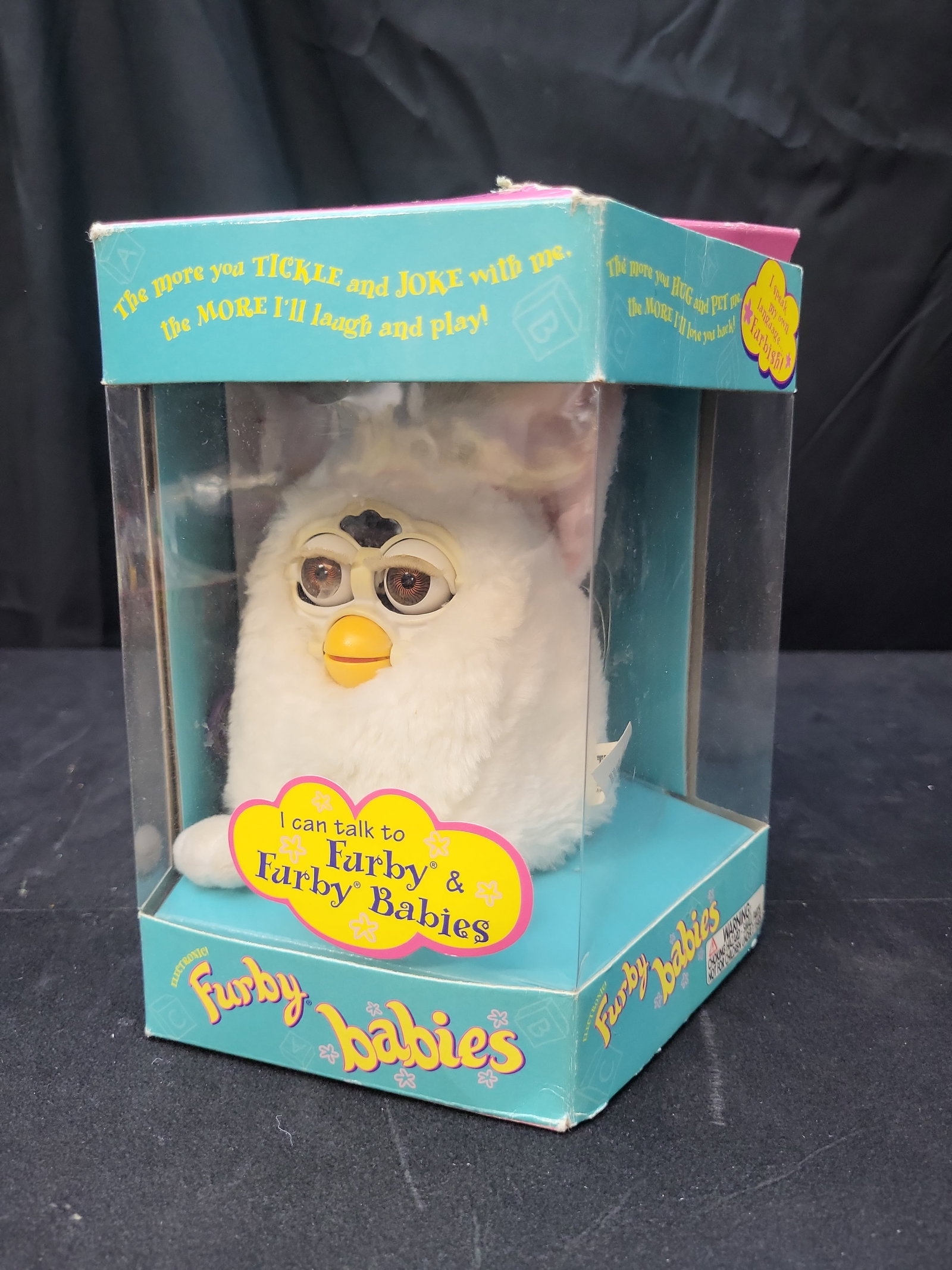 I03663 | 1999 Tiger Electronics Furby Babies Model 70-940 Snow White Electronic Plush Toy: BID PER WHAT YOU SEE IN THE PHOTO, NOT THE AI GENERATED TITLES AND DESCRIPTIONS! 1999 Tiger Electronics Furby Babies Model 70-940 Snow White Electronic Plush Toy This is a vintage 1999 Furby Babies el