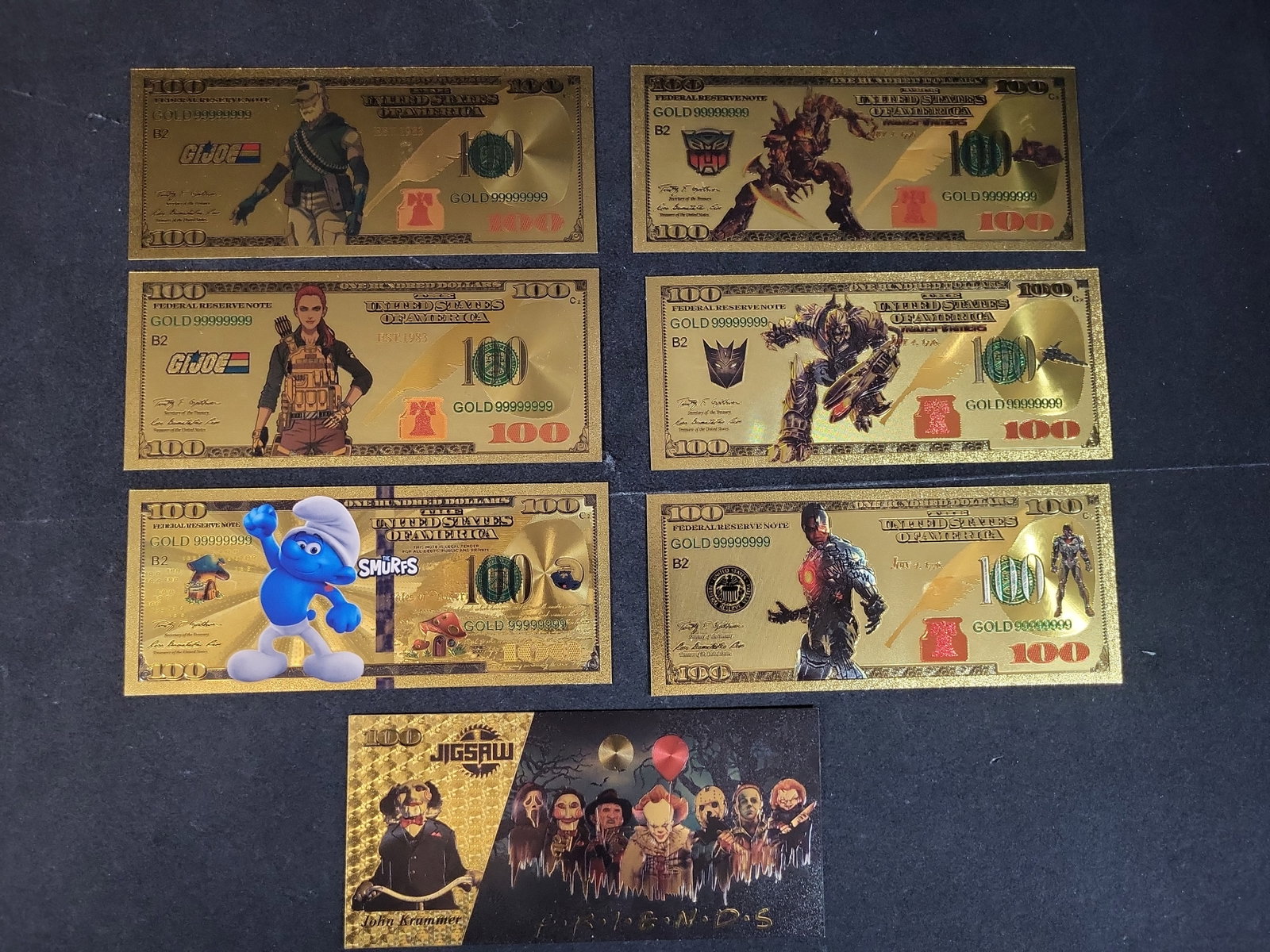 I03653 | Seven Novelty Gold Foil Banknotes Featuring G.I. Joe, Transformers, The Smurfs, and (1 of 7)