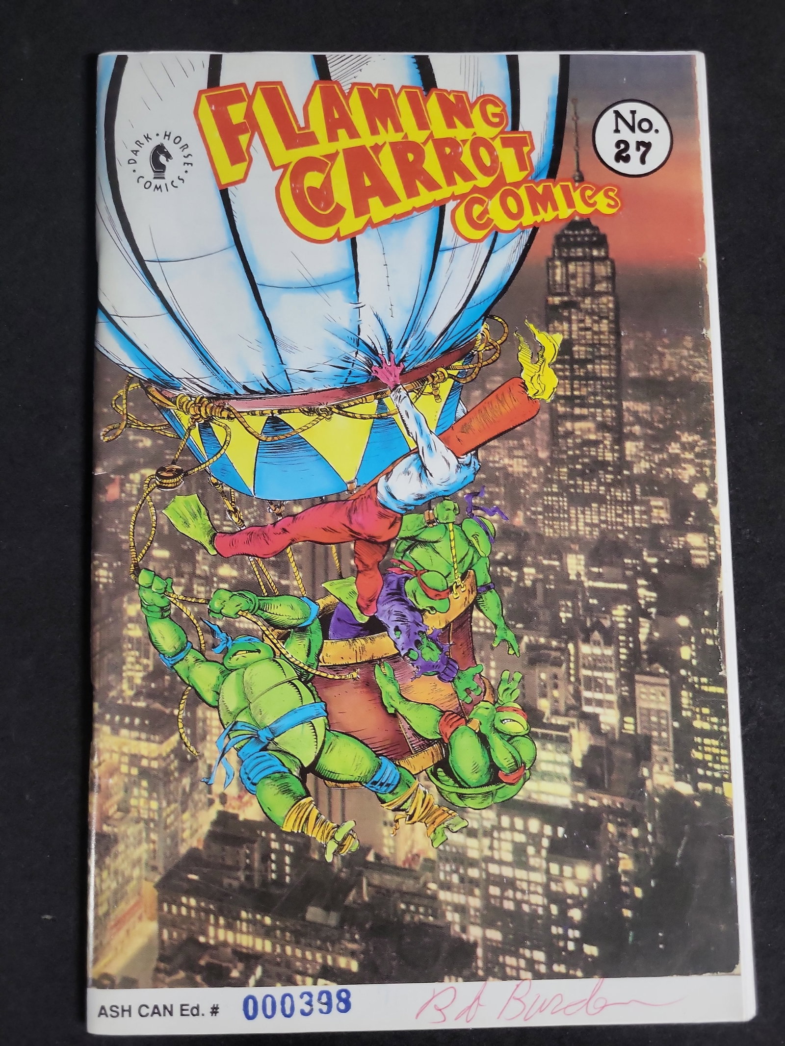 I03996 | Signed Flaming Carrot Ashcan 27: IMPORTANT â€“ PLEASE REVIEW BEFORE BIDDING: Aeron House makes every effort to accurately identify and describe each lot; however, titles and descriptions may contain errors, omissions, or AI-a