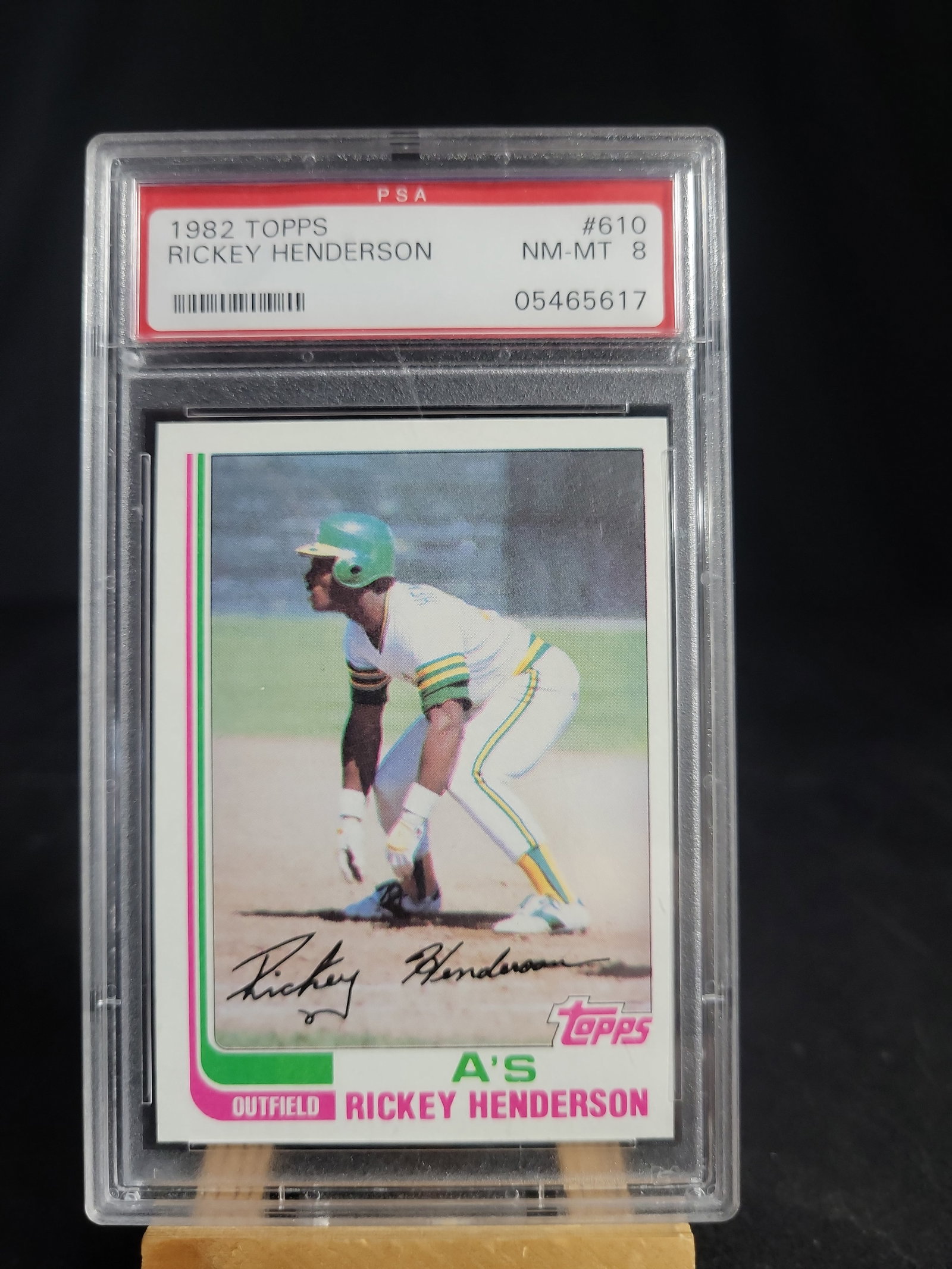 I04123 | 1982 Topps Rickey Henderson PSA 8: IMPORTANT â€“ PLEASE REVIEW BEFORE BIDDING: Aeron House makes every effort to accurately identify and describe each lot; however, titles and descriptions may contain errors, omissions, or AI-a