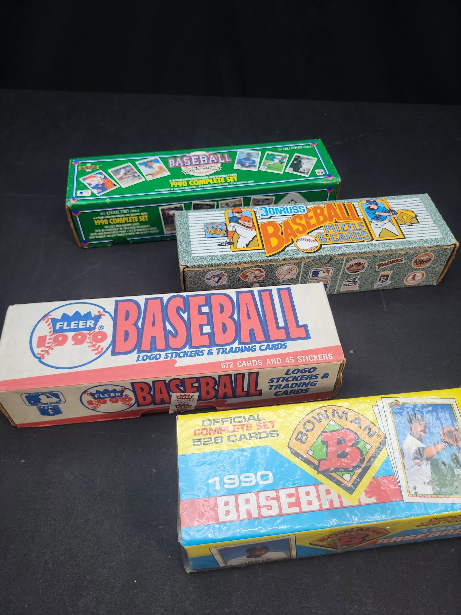 I04102 | Group of 1990 Baseball Card Sets: IMPORTANT â€“ PLEASE REVIEW BEFORE BIDDING: Aeron House makes every effort to accurately identify and describe each lot; however, titles and descriptions may contain errors, omissions, or AI-a