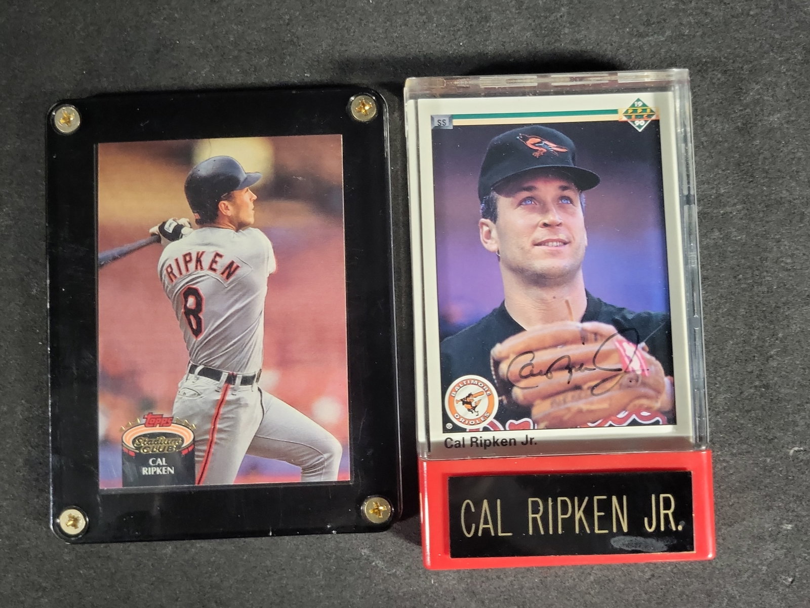 I04637 | Two Cal Ripken Jr. Baseball Cards (Signed): IMPORTANT â€“ PLEASE REVIEW BEFORE BIDDING: Aeron House makes every effort to accurately identify and describe each lot; however, titles and descriptions may contain errors, omissions, or AI-a