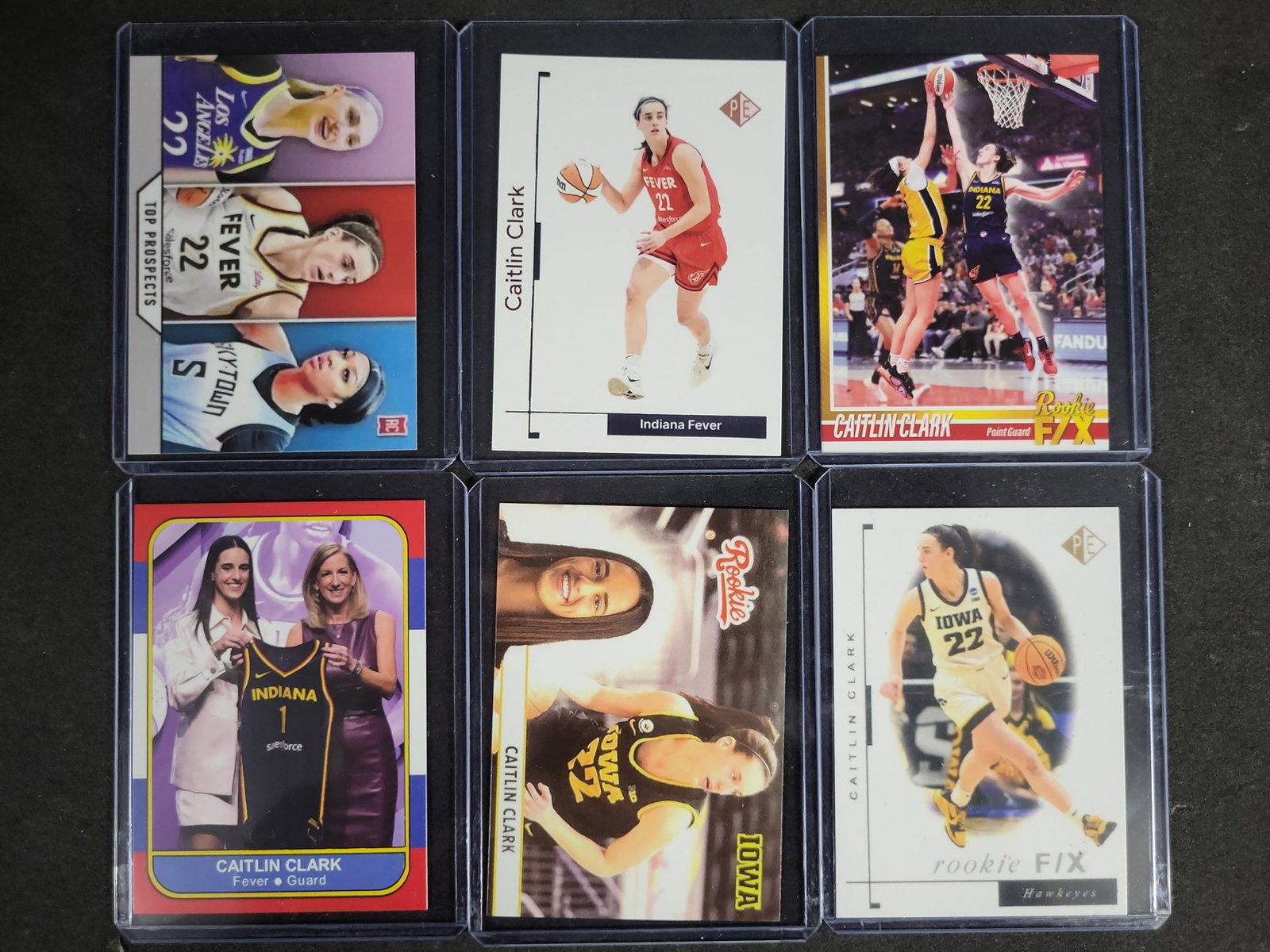 I04198 | A Group of Caitlin Clark Rookie Cards: IMPORTANT â€“ PLEASE REVIEW BEFORE BIDDING: Aeron House makes every effort to accurately identify and describe each lot; however, titles and descriptions may contain errors, omissions, or AI-a
