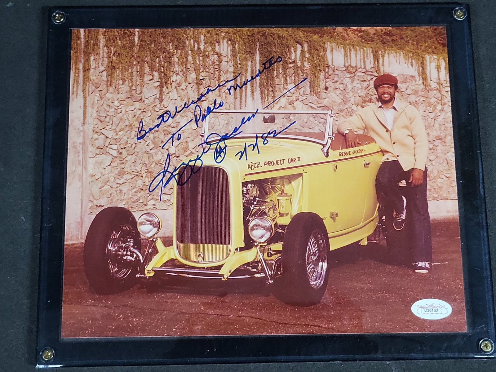 I04432 | Signed Reggie Jackson Hot Rod Photograph: IMPORTANT â€“ PLEASE REVIEW BEFORE BIDDING: Aeron House makes every effort to accurately identify and describe each lot; however, titles and descriptions may contain errors, omissions, or AI-a