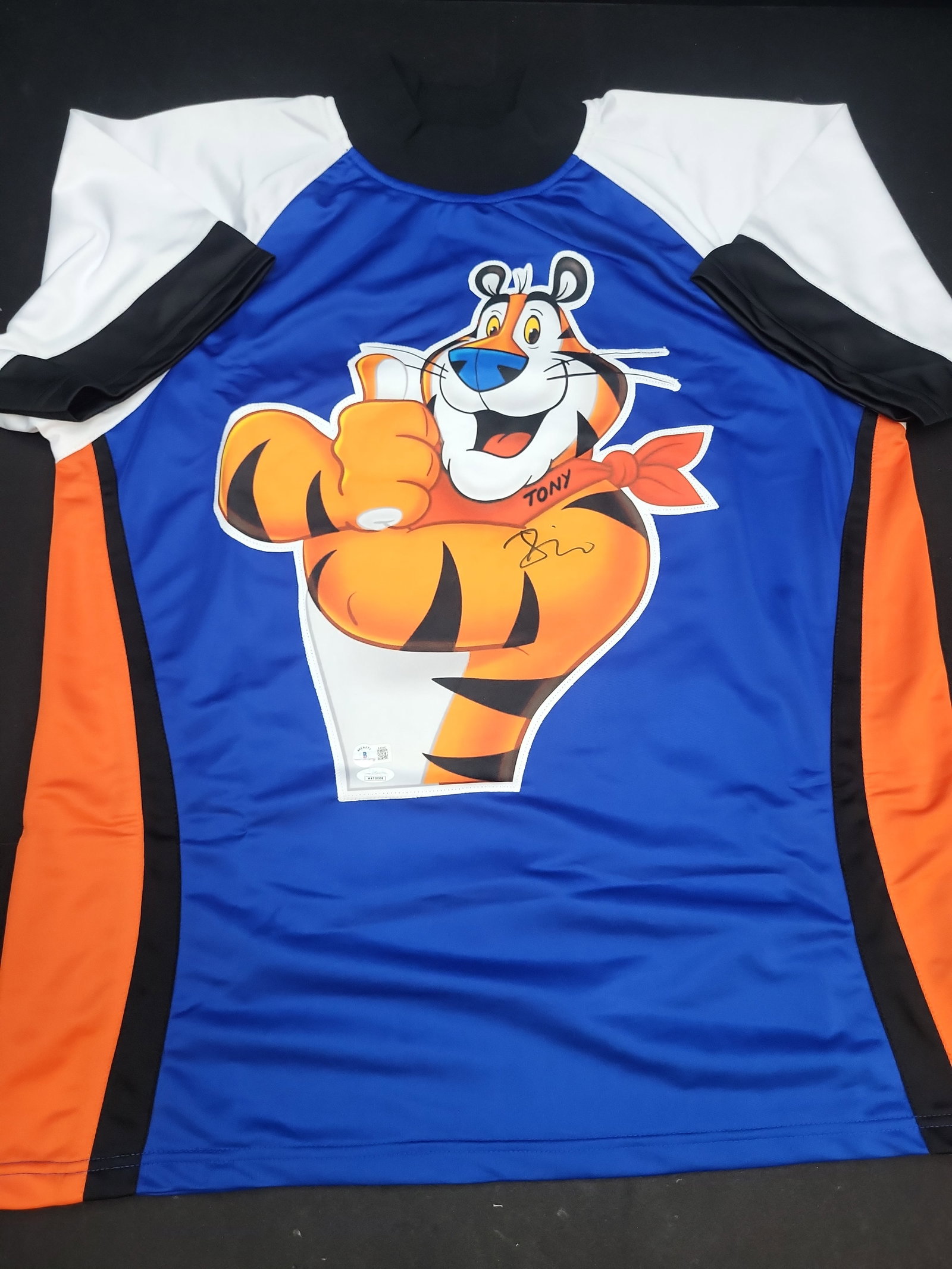 I04324 | Signed Tony the Tiger Custom Jersey JSA & Beckett: IMPORTANT â€“ PLEASE REVIEW BEFORE BIDDING: Aeron House makes every effort to accurately identify and describe each lot; however, titles and descriptions may contain errors, omissions, or AI-a