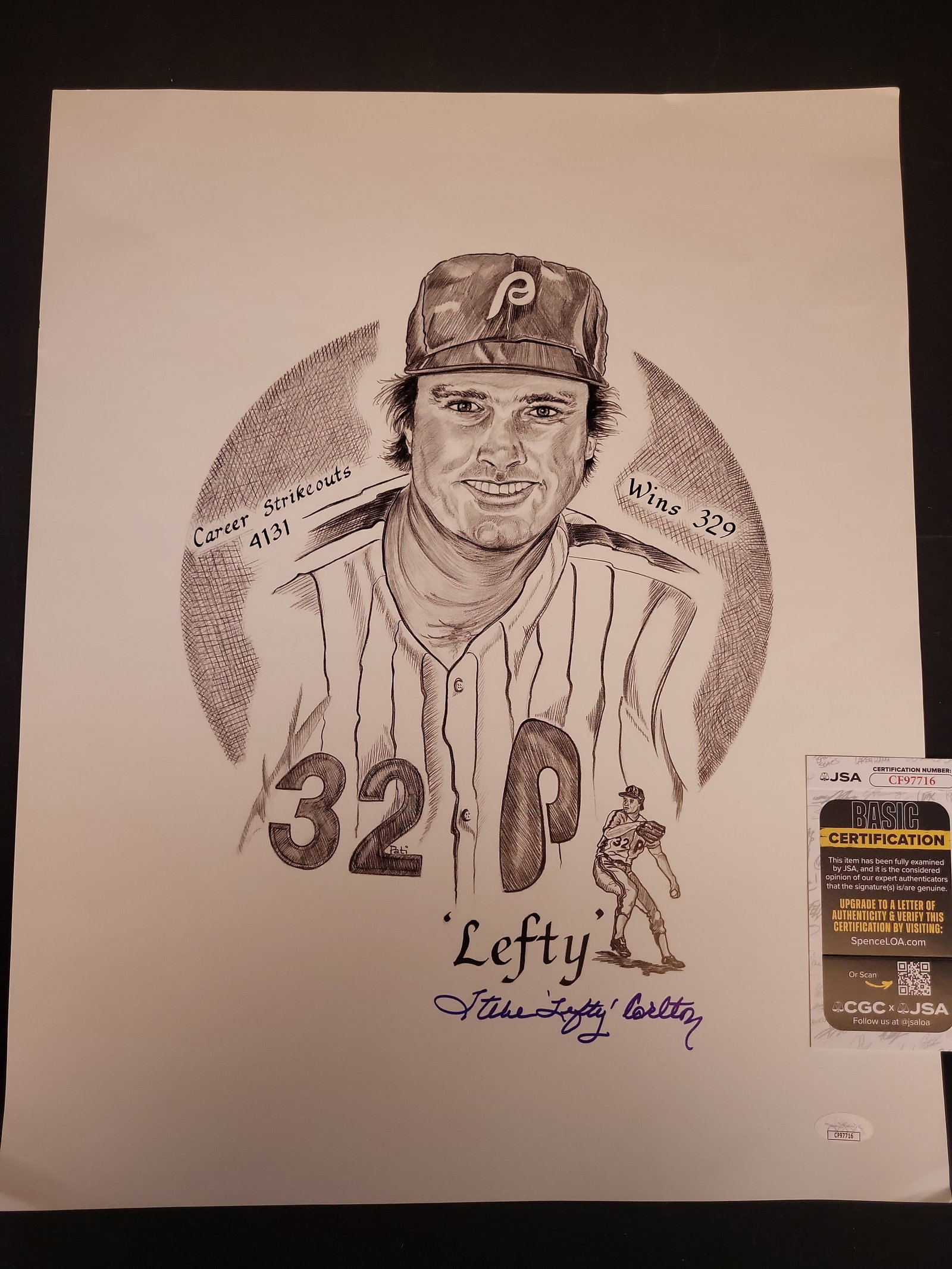 I03454 | Steve Carlton Autographed Philadelphia Phillies Art Print Certified by JSA: IMPORTANT â€“ PLEASE REVIEW BEFORE BIDDING: Aeron House makes every effort to accurately identify and describe each lot; however, titles and descriptions may contain errors, omissions, or AI-a