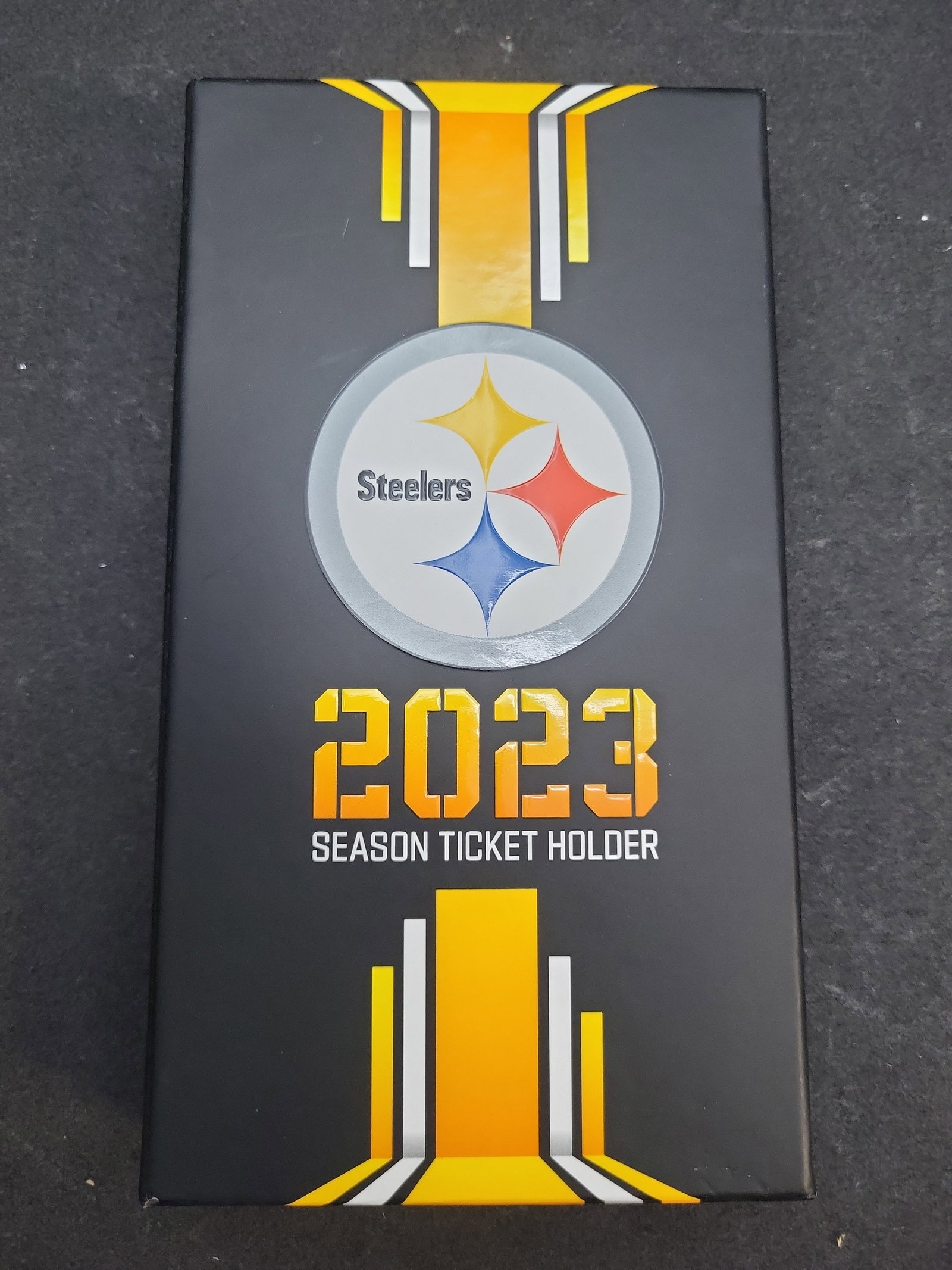 I04717 | 2023 Pittsburgh Steelers Season Ticket Souvenir: IMPORTANT â€“ PLEASE REVIEW BEFORE BIDDING: Aeron House makes every effort to accurately identify and describe each lot; however, titles and descriptions may contain errors, omissions, or AI-a