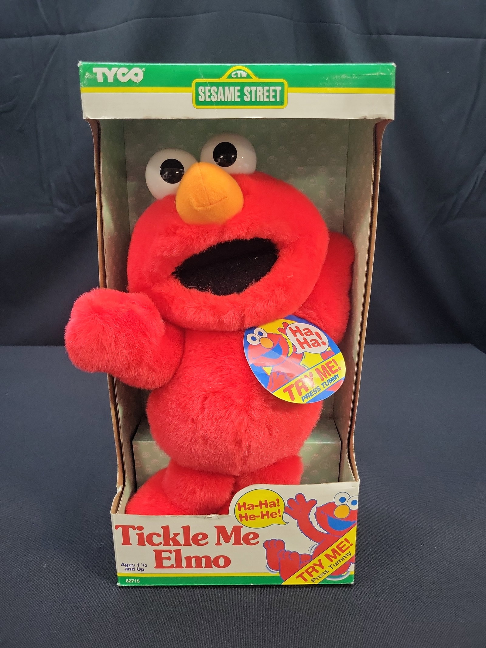 I04820 | Tyco Tickle Me Elmo in Box: IMPORTANT â€“ PLEASE REVIEW BEFORE BIDDING: Aeron House makes every effort to accurately identify and describe each lot; however, titles and descriptions may contain errors, omissions, or AI-a