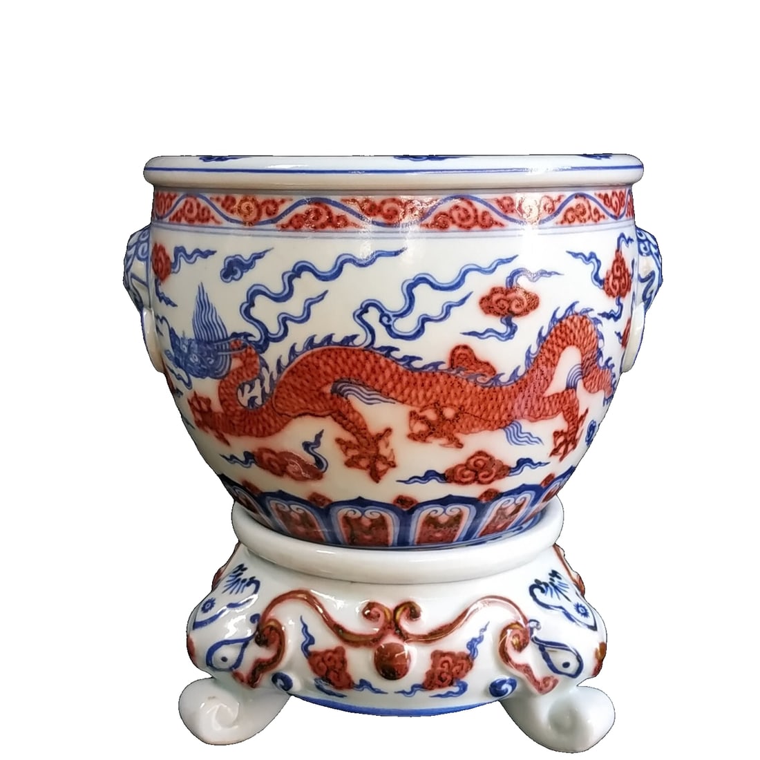 Ming Dynasty Blue and Red Underglaze Hand-painted Dragon Pattern Jar: This Ming Xuande blue and white underglaze red hand-painted dragon pattern jar features a plump and well-proportioned shape, typical of official kiln works from the Ming Dynasty. The glaze on the jar