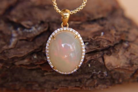 18K Gold Inlaid 6.2ct Opal Pendant: 18K Gold Plated Opal and Diamond PendantMain Stone 6.2ct - Beautiful ColorThick Gold Setting with Full Reverse Diamonds 1.International Freight: Foreign shipping charges are determined by