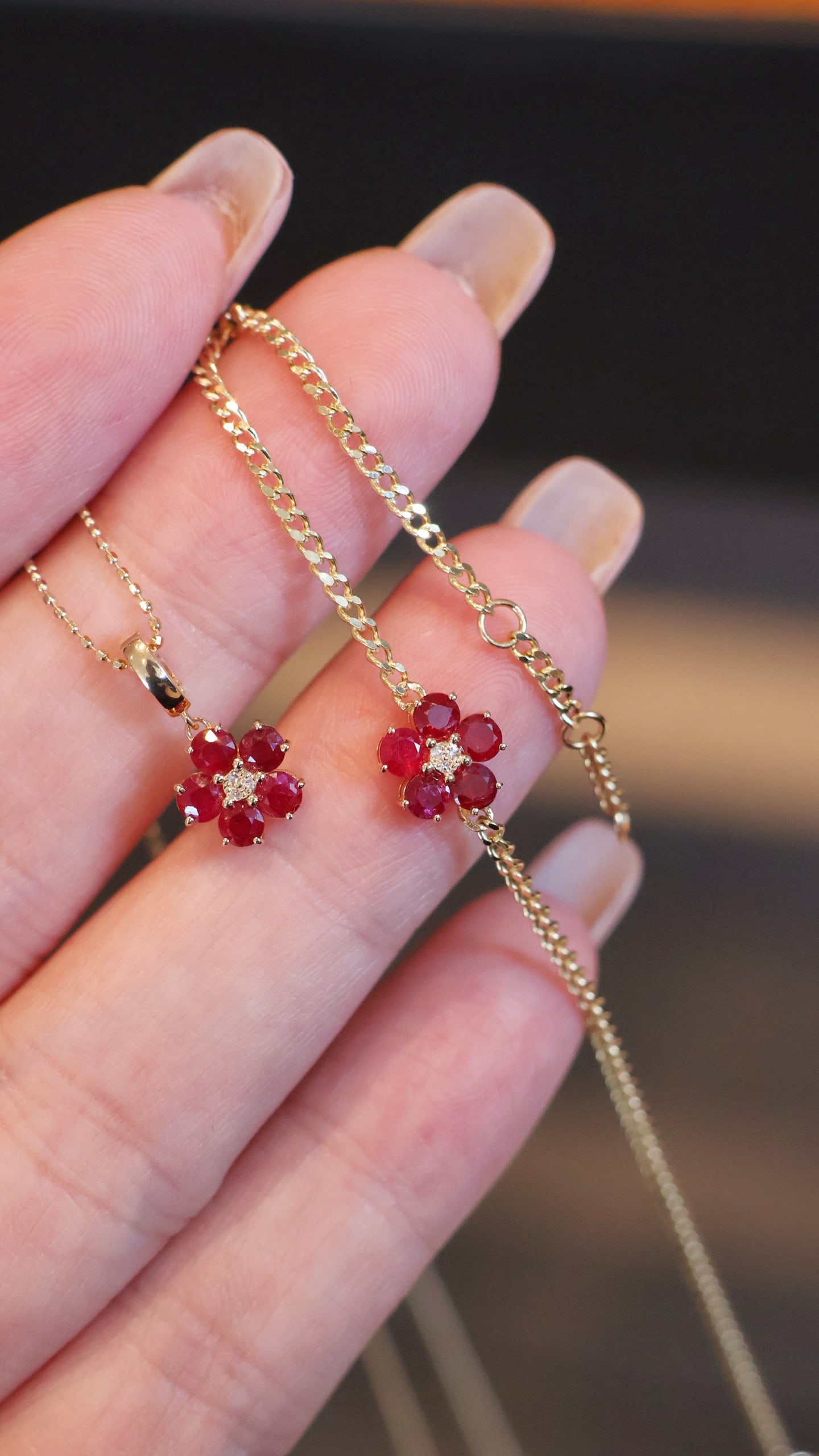 18k Ruby Flower Bracelet Pendant: This 18K ruby flower bracelet and pendant, with its rich pigeon blood red rubies, emit a scorching glow. The bracelet's petal-shaped chain links are flexible and comfortable on the wrist, flowing like