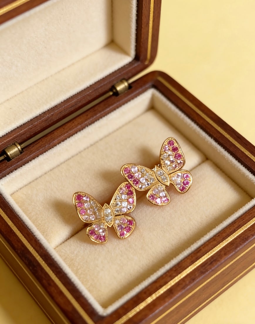 18k Natural Diamond Gradient Pink-Blue Sapphire Butterfly Earrings: This earring is inspired by the elegant dance of butterflies, with the gradient hues of pink and blue gemstones shimmering with every gentle sway. The embellishment of natural diamonds adds