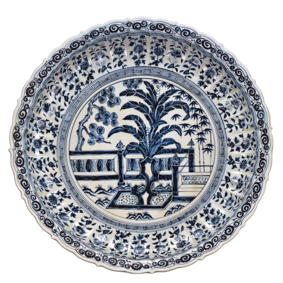 Early Ming Blue and White Floral Plate: An early Ming dynasty blue and white porcelain dish with a 'Three Friends of Winter' design, featuring pine, bamboo, and plum blossoms. The dish has a multi-petal chrysanthemum mouth rim and an elegan