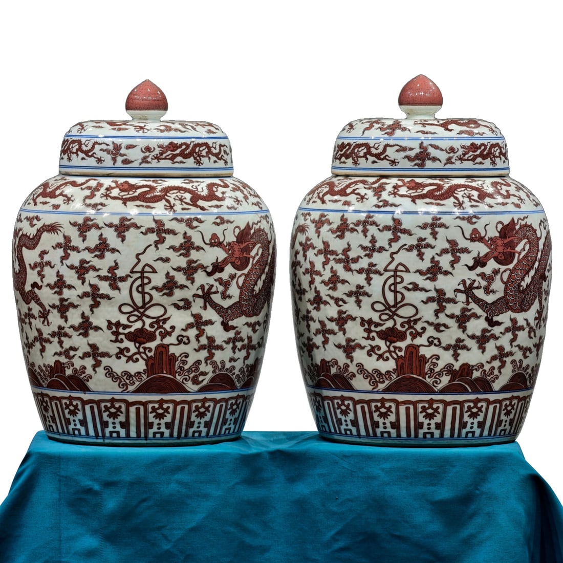 Ming Jiajing Red Glaze Dragon Pattern Jar: A pair of Ming Dynasty Jiajing period copper-red glazed dragon motif covered jars. The jars have a straight mouth and rounded shoulders, gradually tapering towards the bottom, with a knobbed cover ado