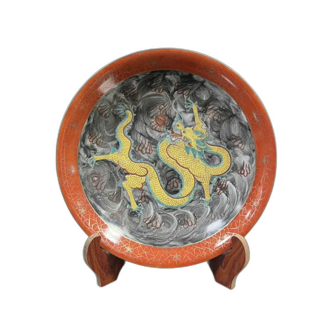 Yongzheng Period Black Enamel Plate: A Yongzheng period ink-colored plate from the Qing Dynasty, with a diameter of 30 centimeters and a height of 6 centimeters. The vibrant Yellow Dragon Five Blessings pattern symbolizes wealth and good